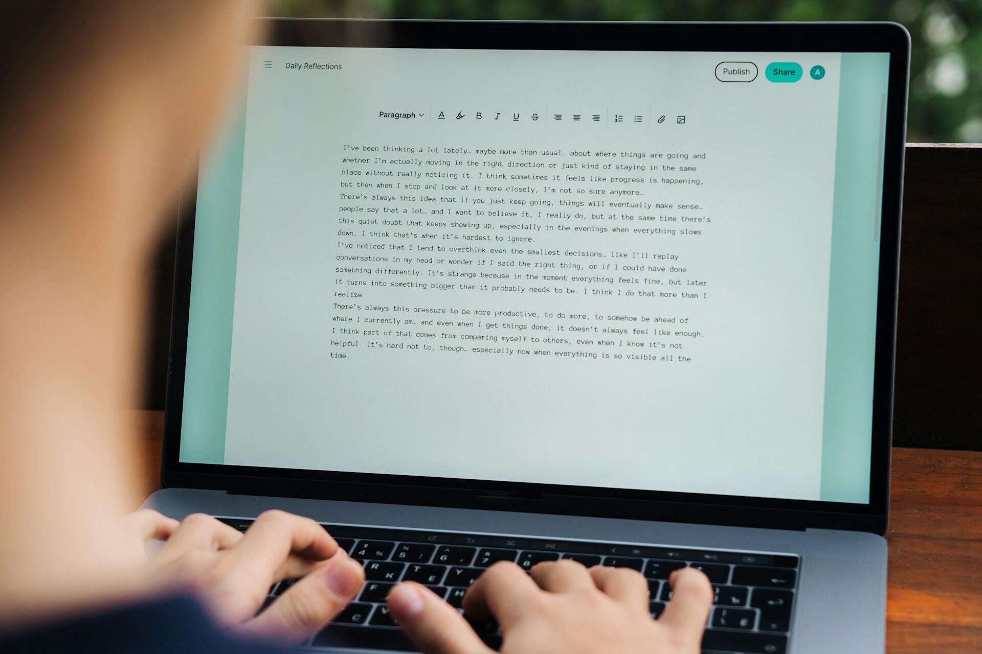 student typing an essay on a computer