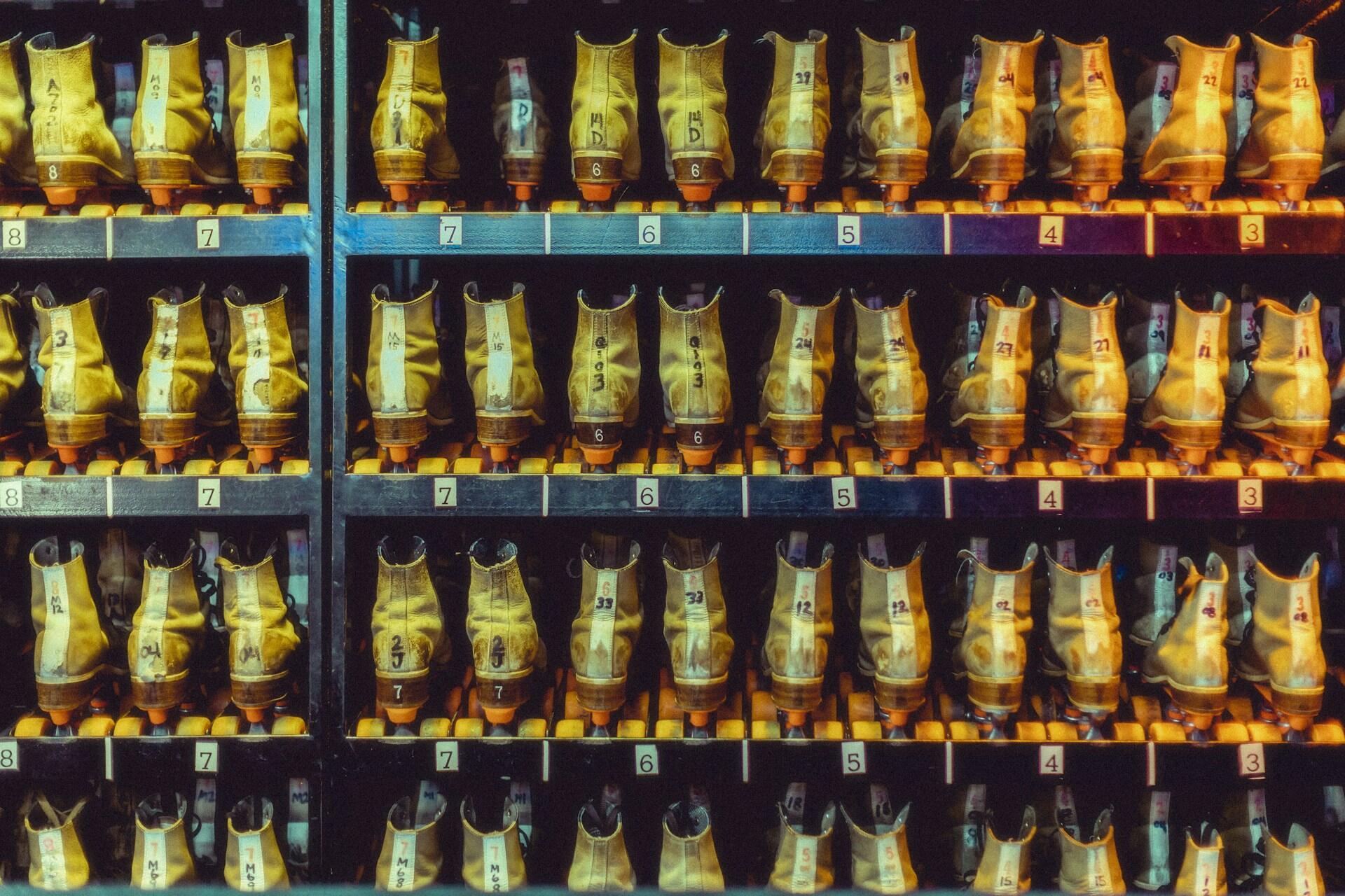 Rows of yellow roller skates arranged by size on shelves