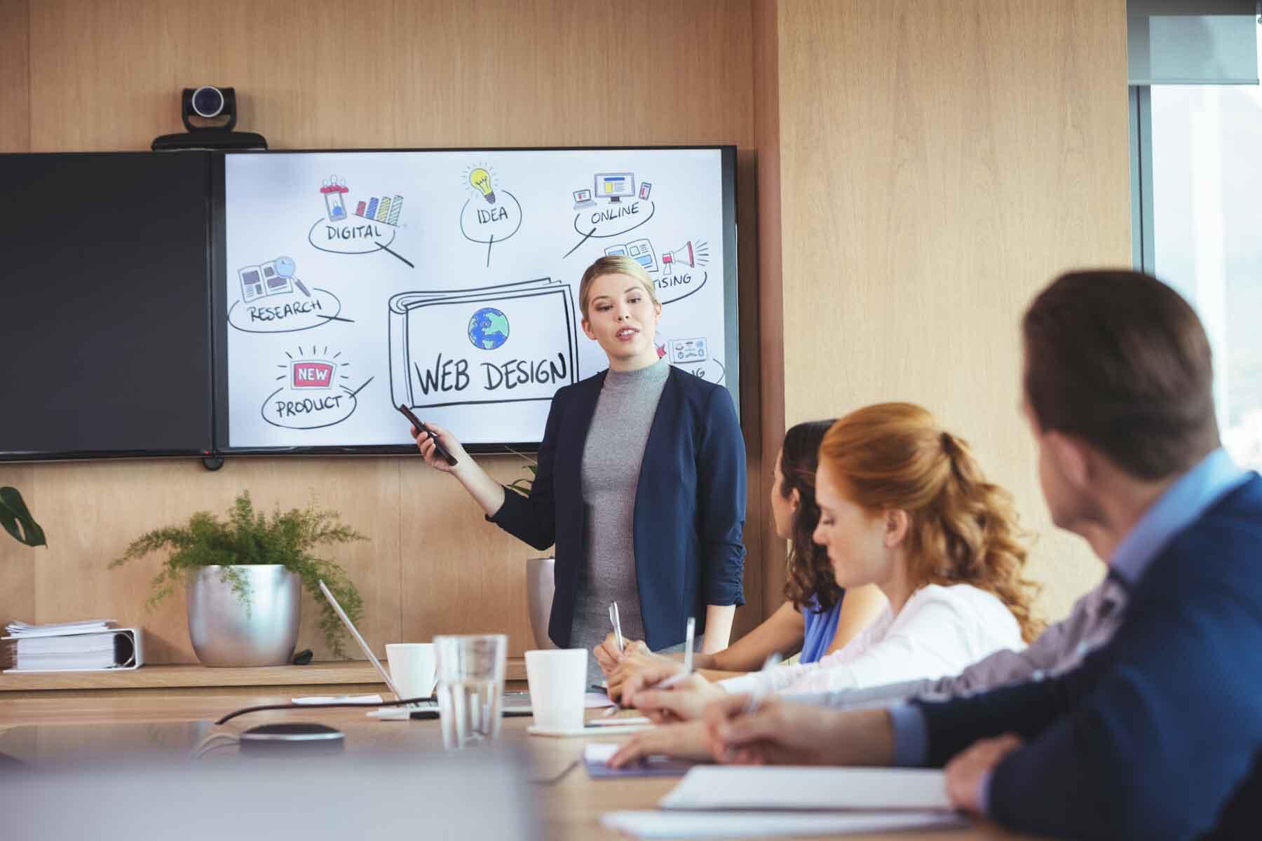 A businesswoman giving a presentation with a smart board during a meeting.