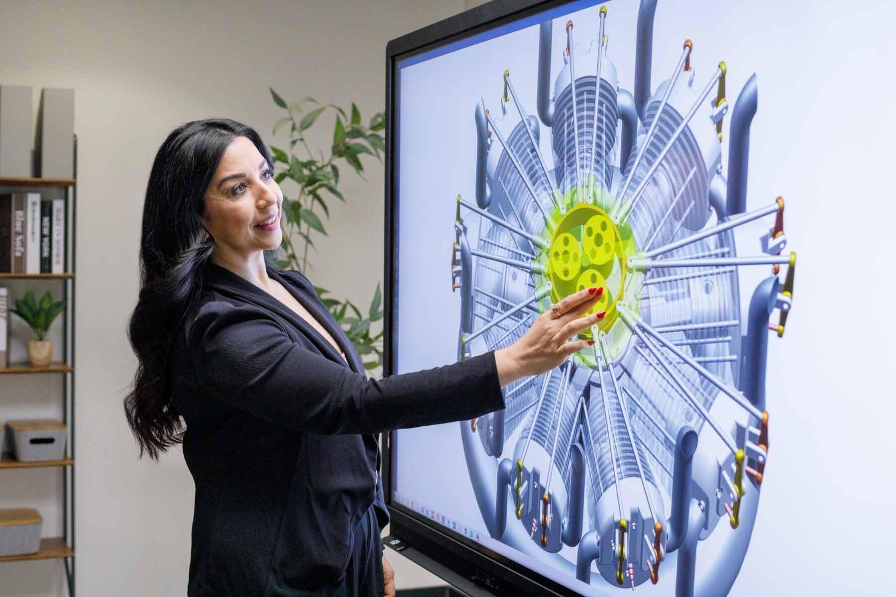 A businesswoman using a Promethean smart panel to review a product design