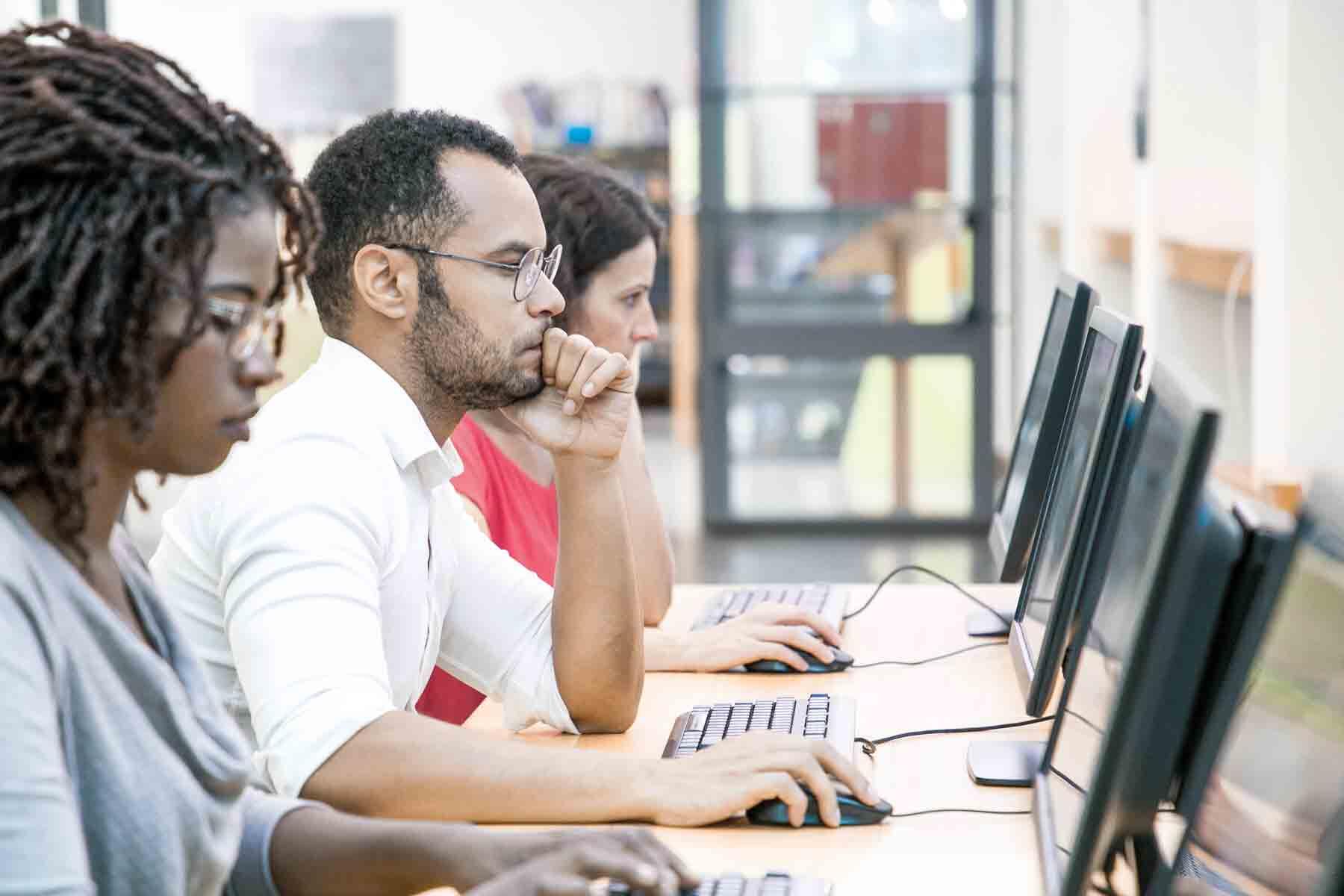 A group of adults taking the GED exam