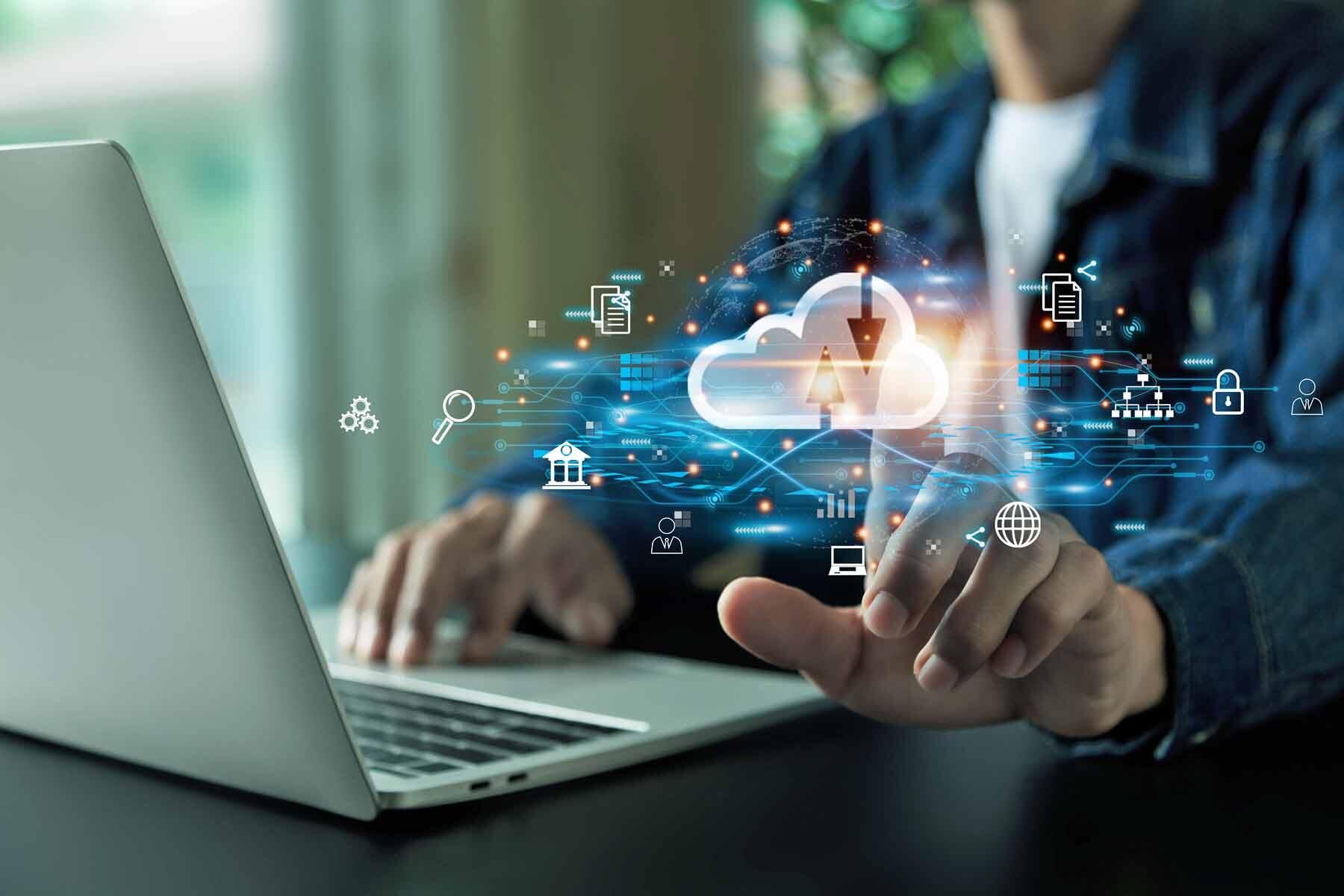 A man with a laptop demonstrating cloud computing technology