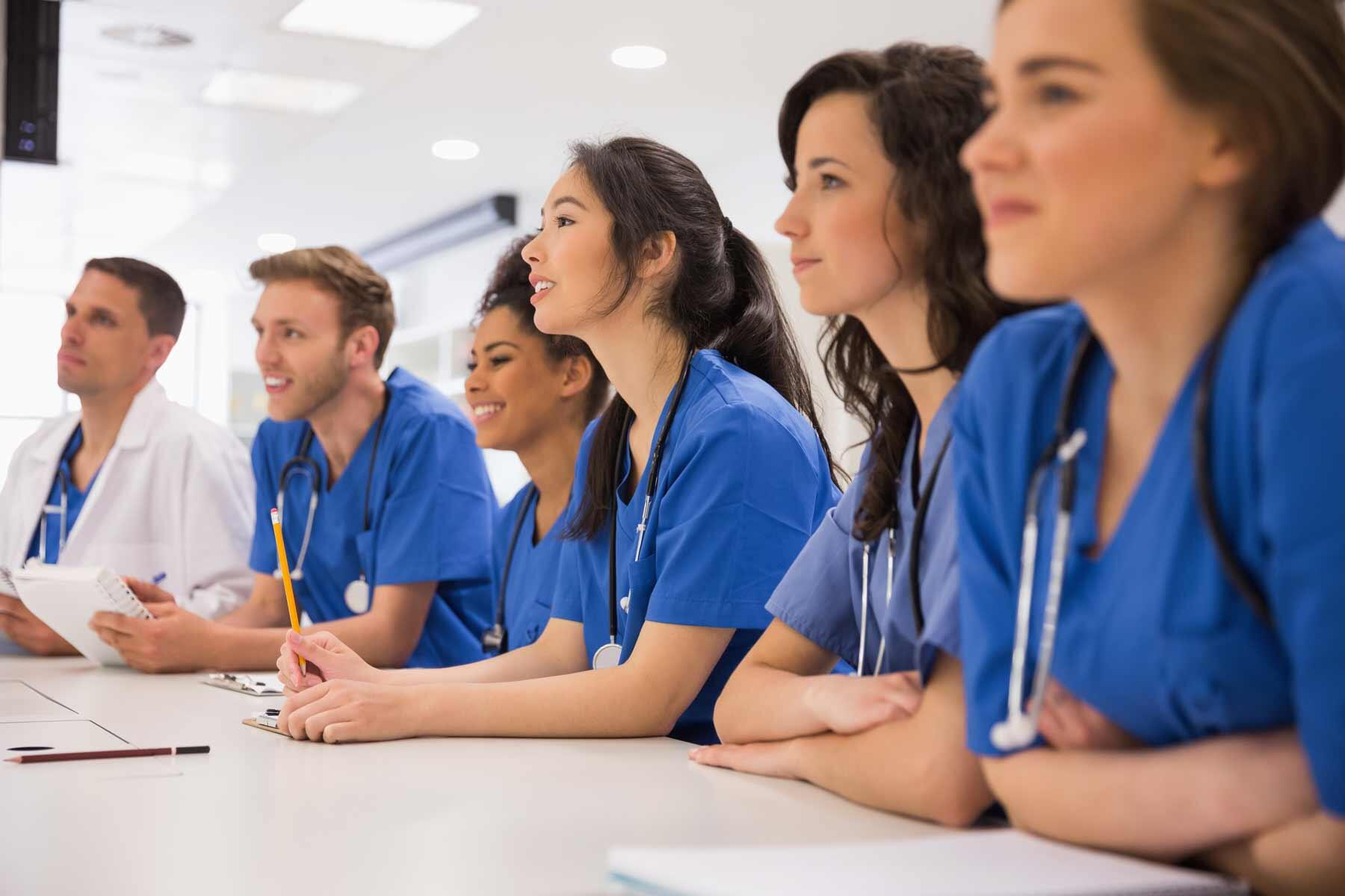 A group of medical school students listening to a lecture.