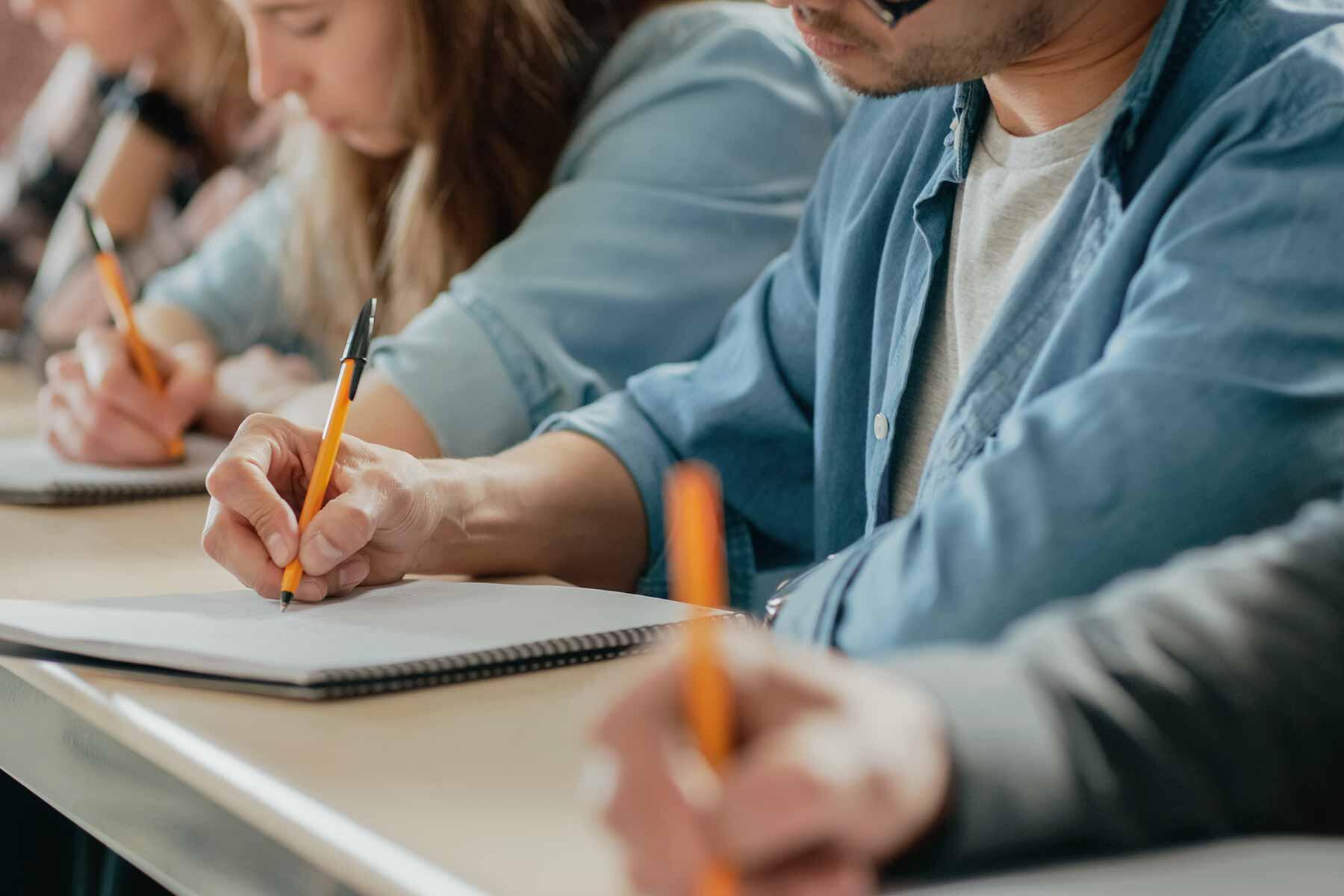 A group of professionals taking a certification exam