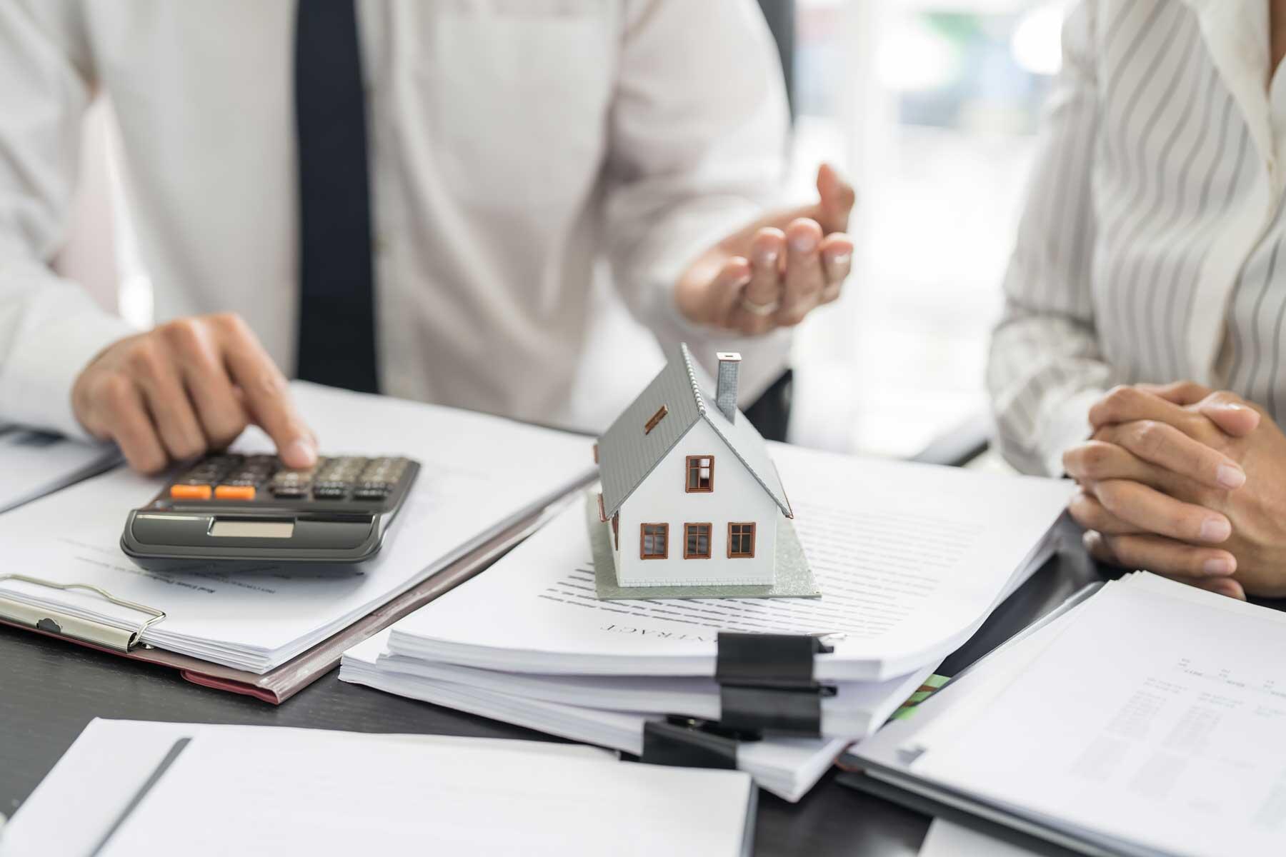 A real estate agent explaining a contract to a home buyer
