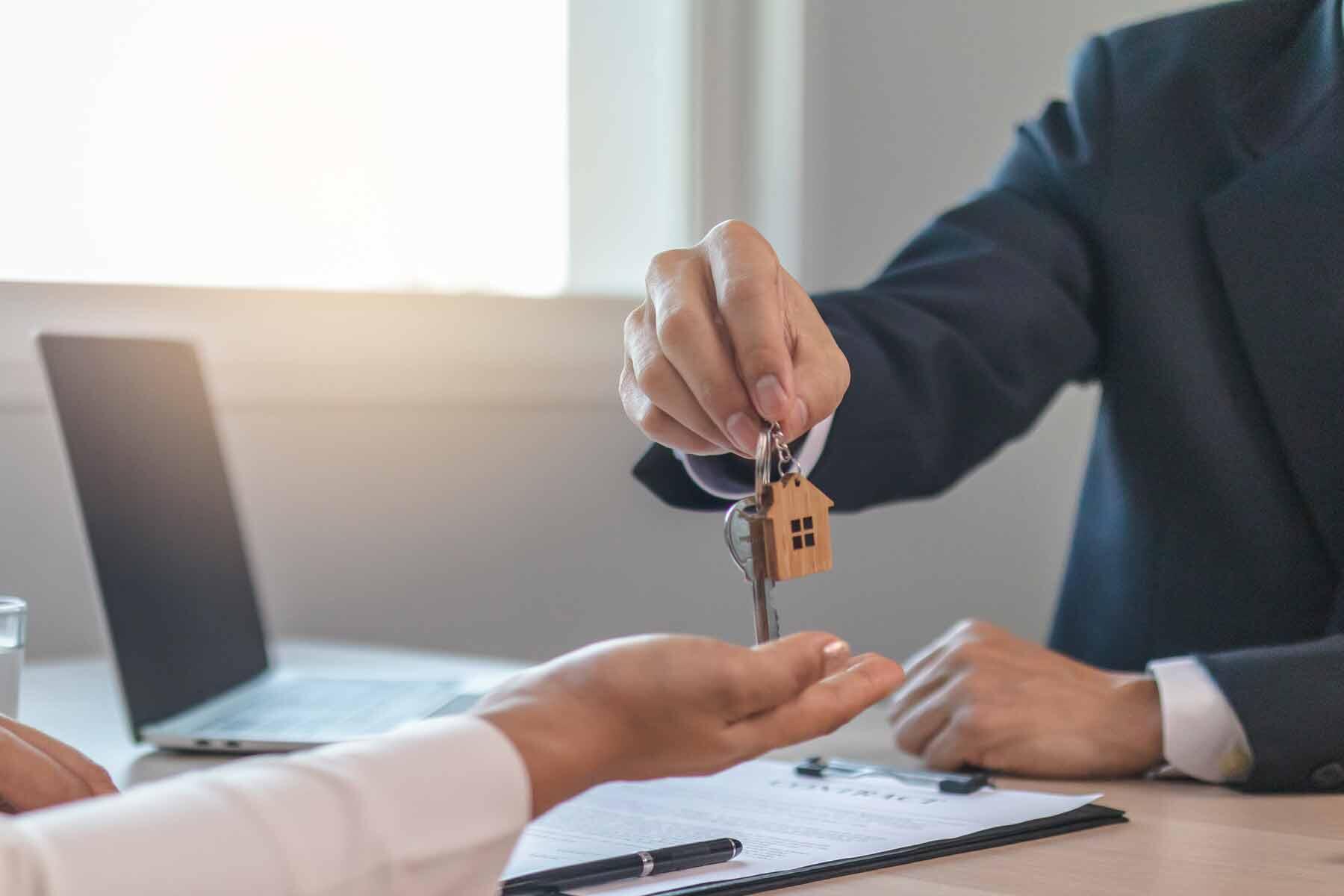 A real estate agent giving house keys to a new homeowner