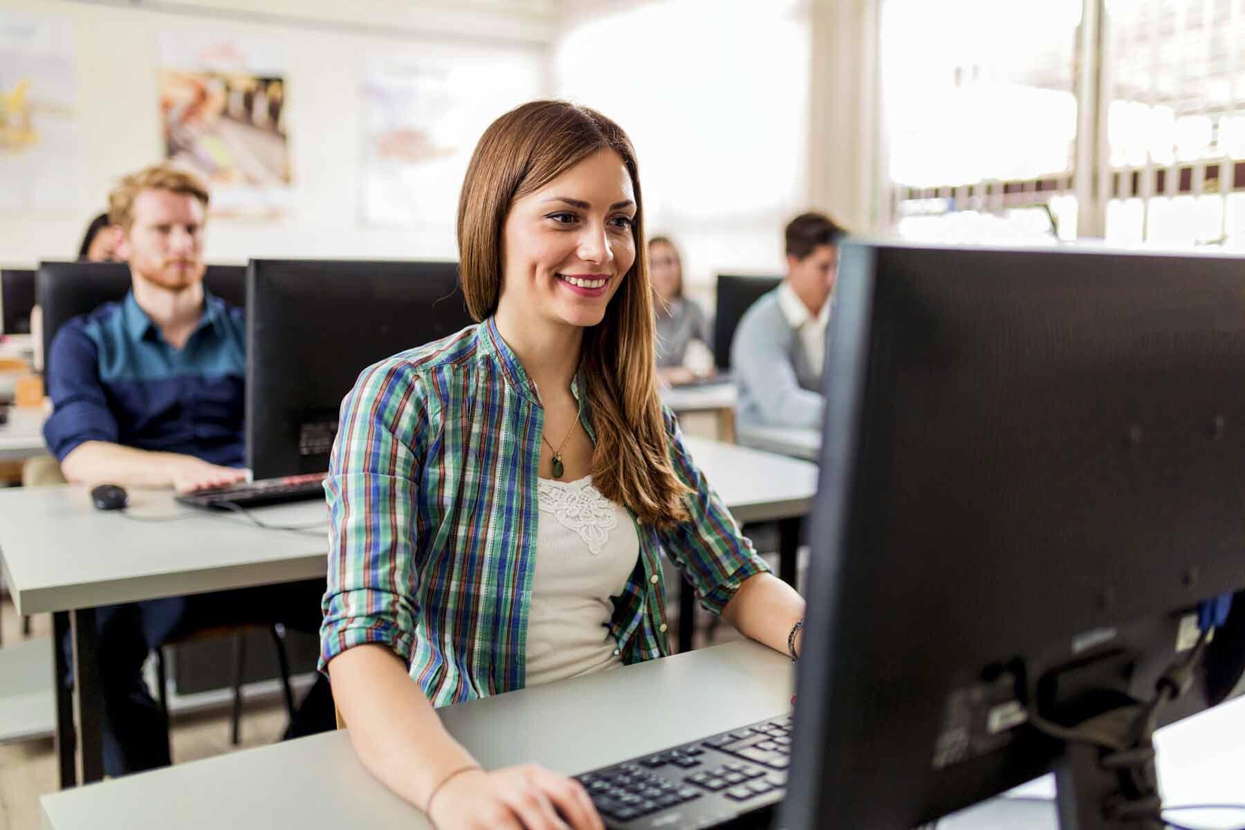A smiling female student viewing her scores at the end of the test