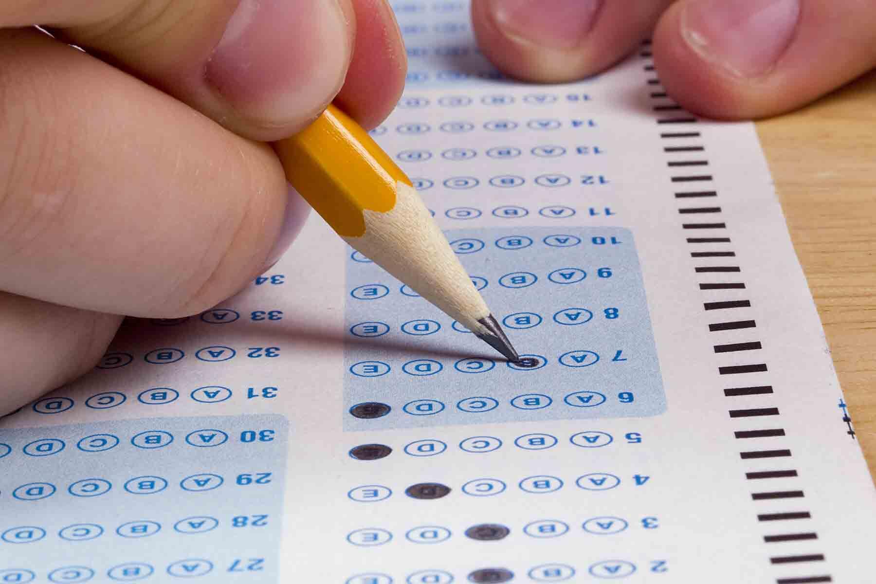 A student filling out answers on the SAT exam.