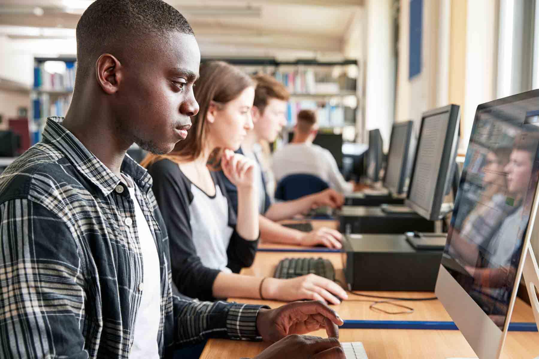 A group of students taking an exam using school computers