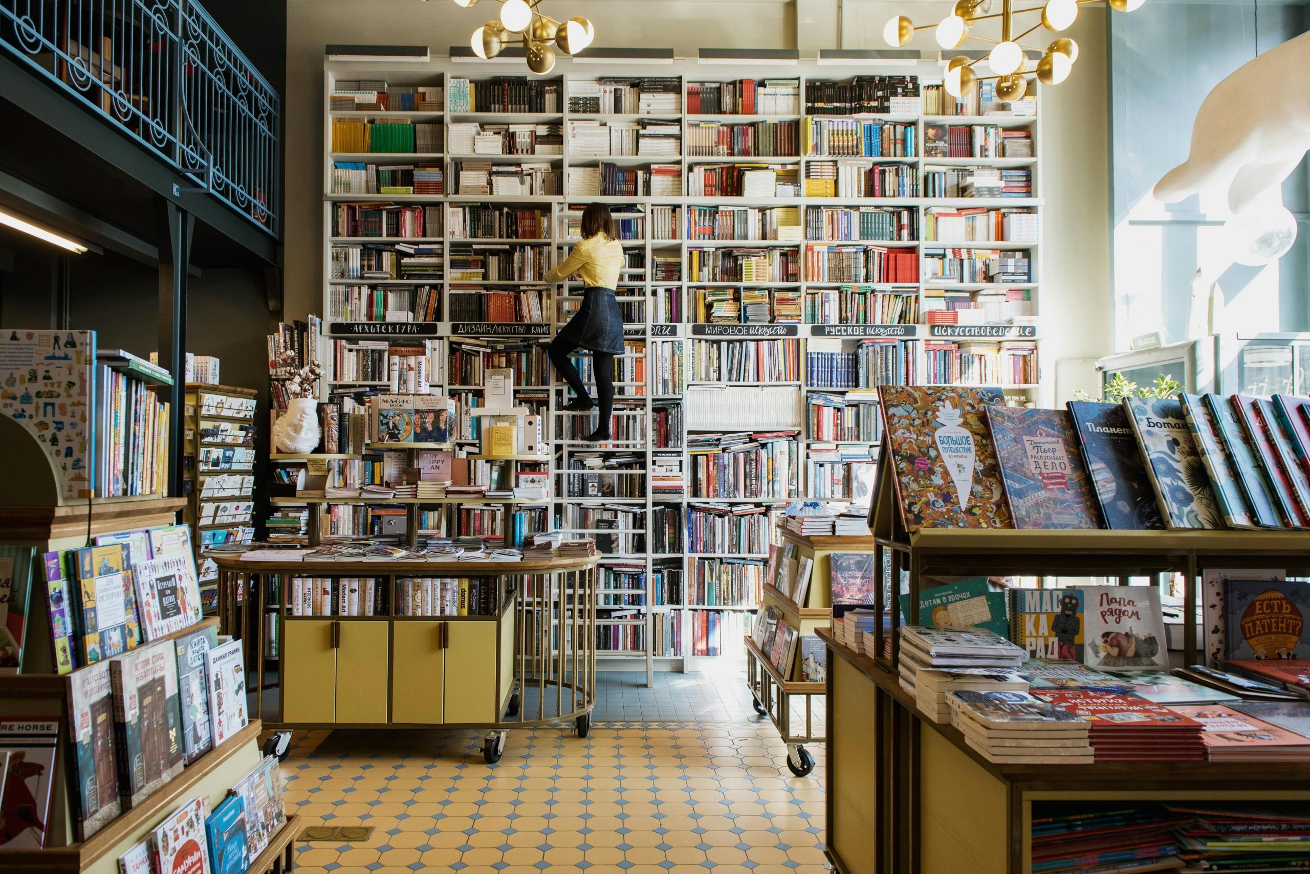 biblioteca y persona buscando un libro