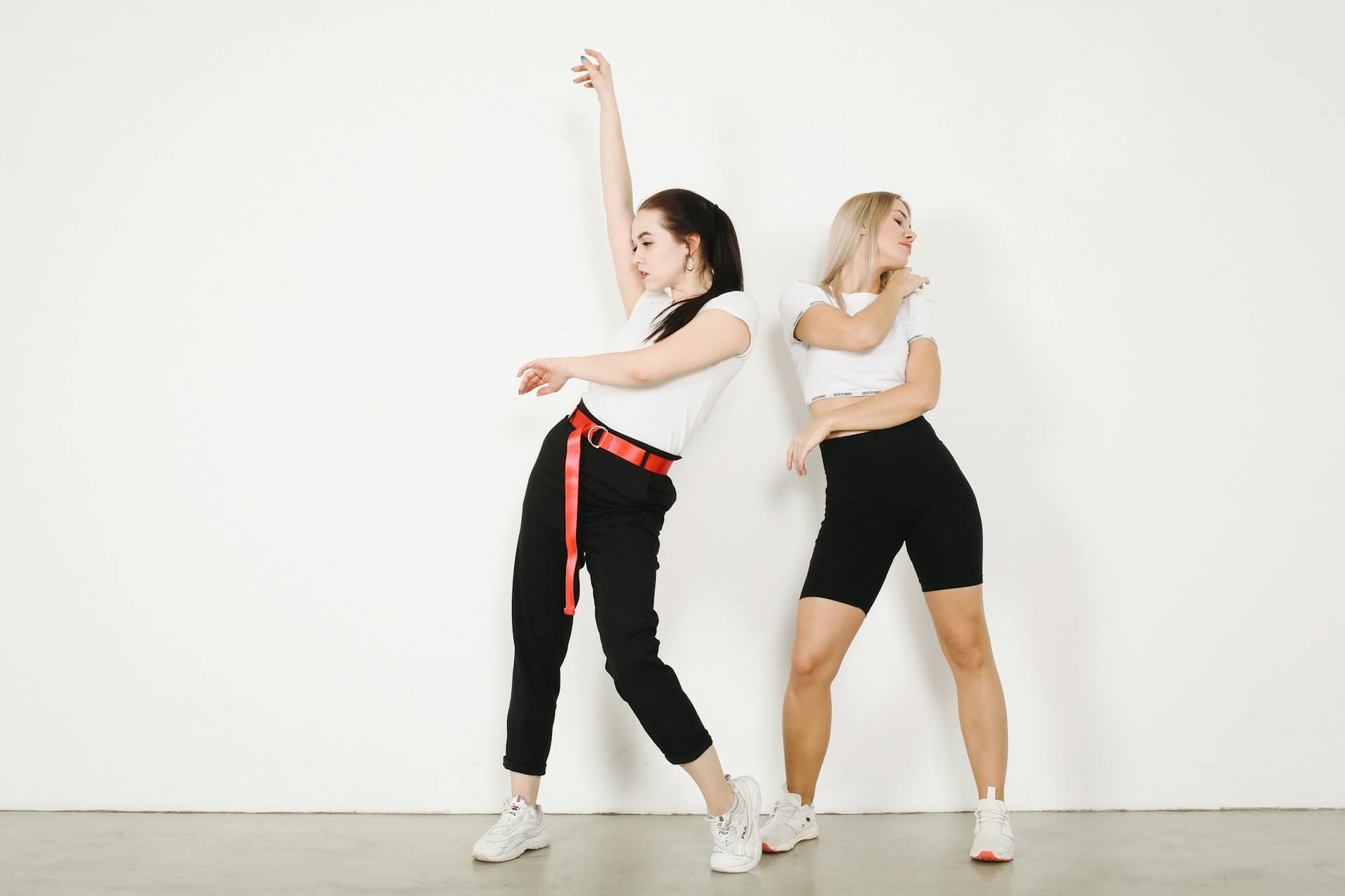 Dos mujeres bailando vestidas en blanco y negro.