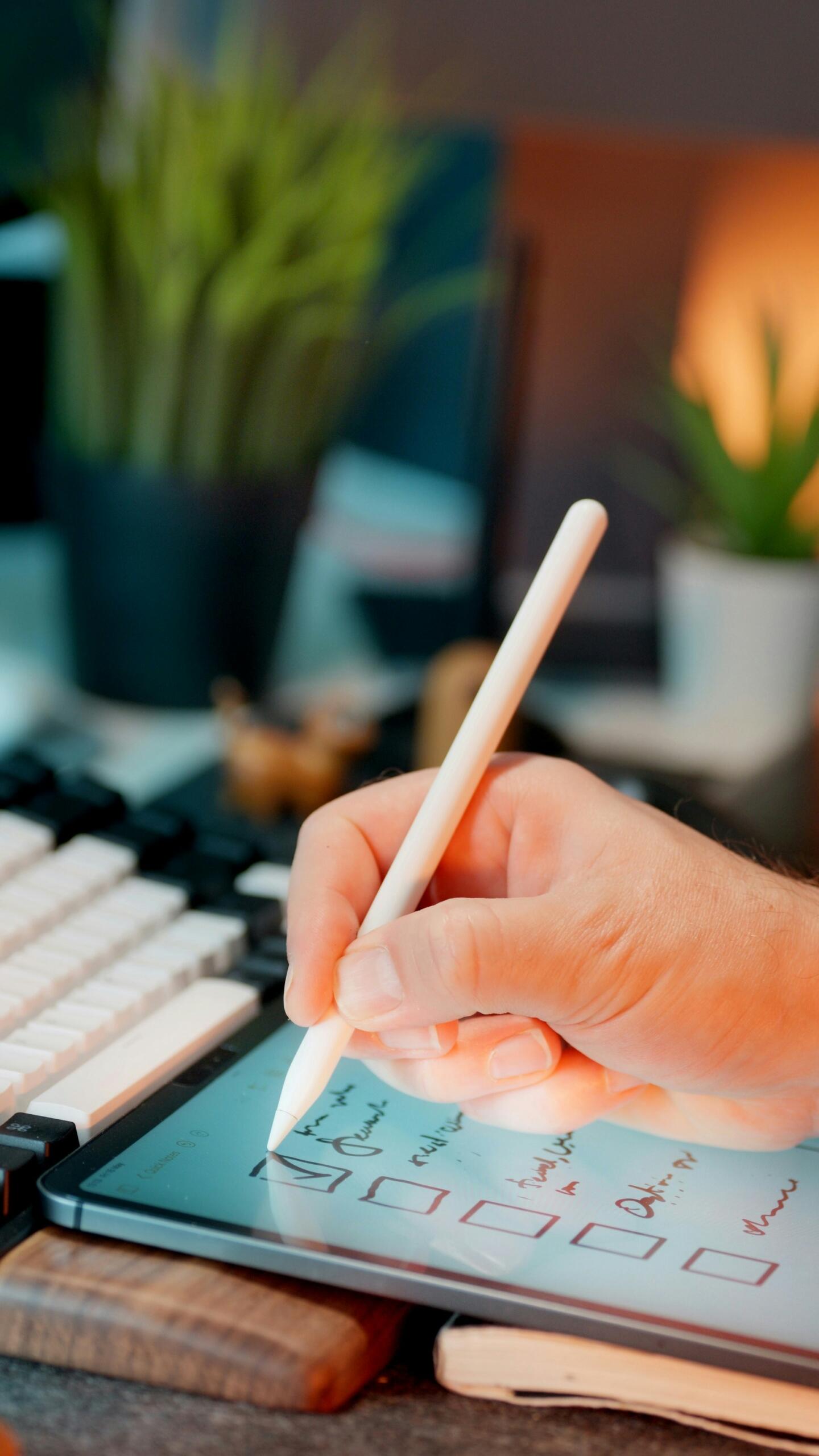 Persona armando un checklist para ordenar su estudio en las paginas para aprender aleman. Fuente: Jakub Żerdzicki de Unsplash