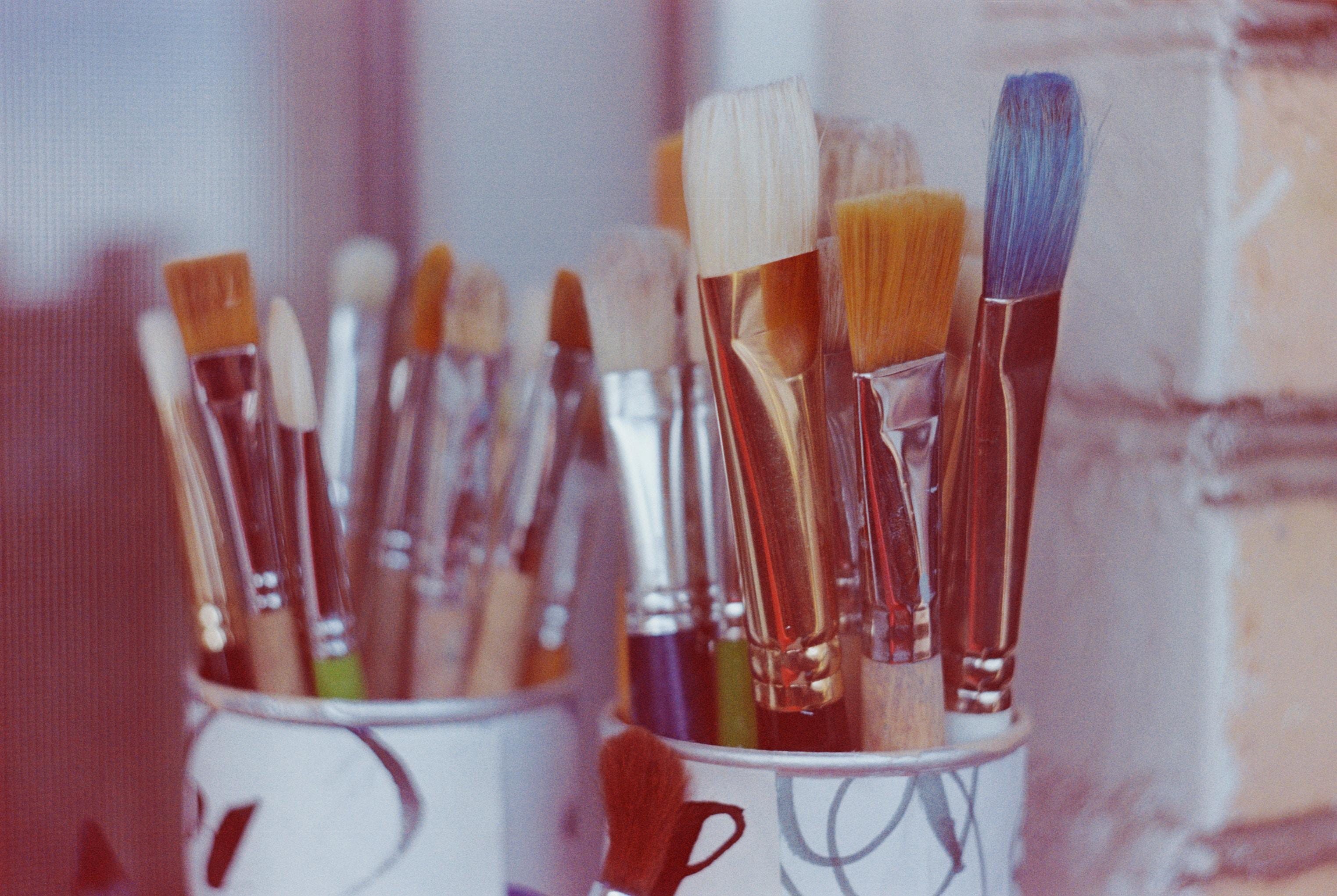 artist's paint brushes in jars