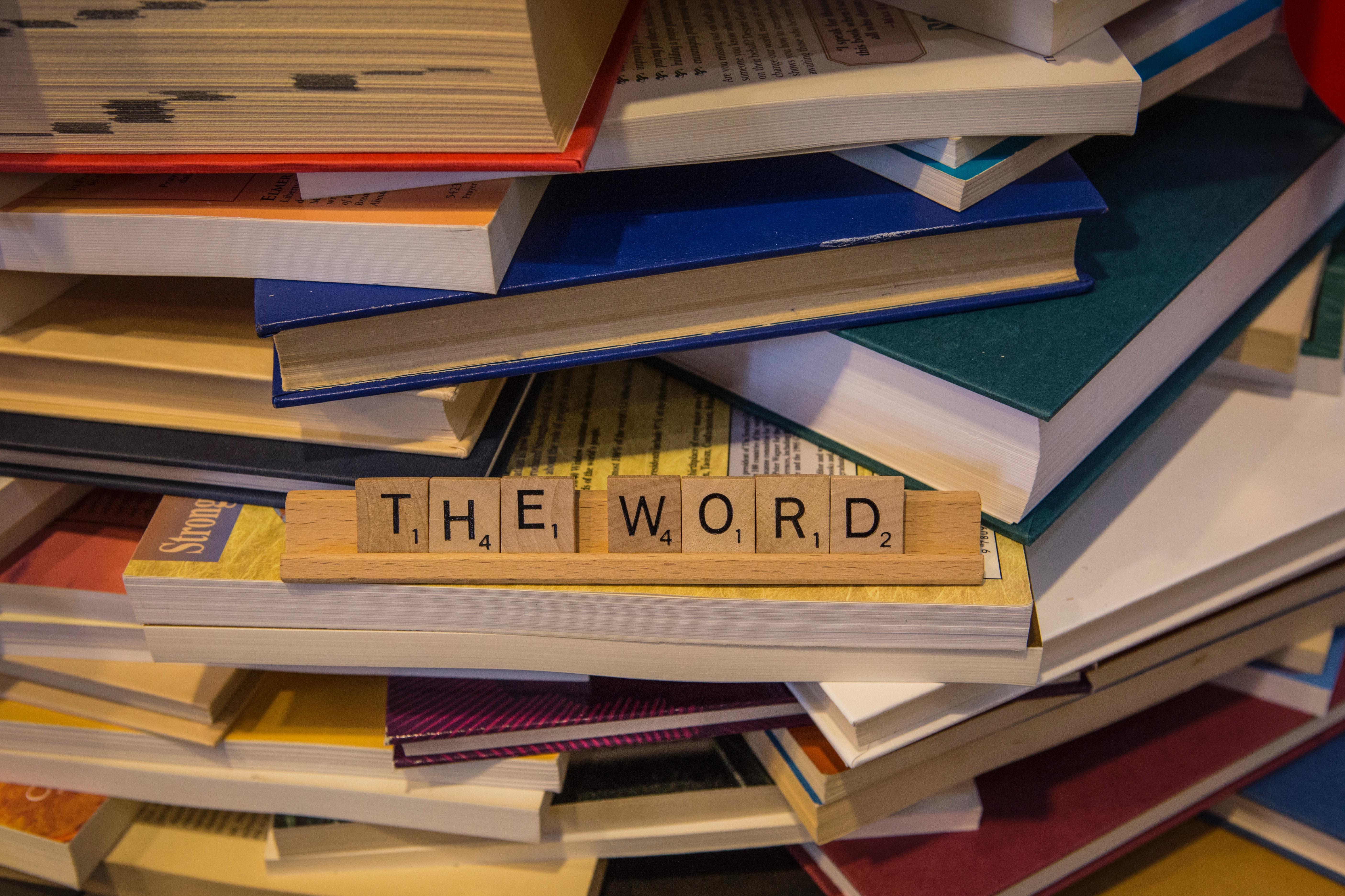 scrabble tiles and pile of books