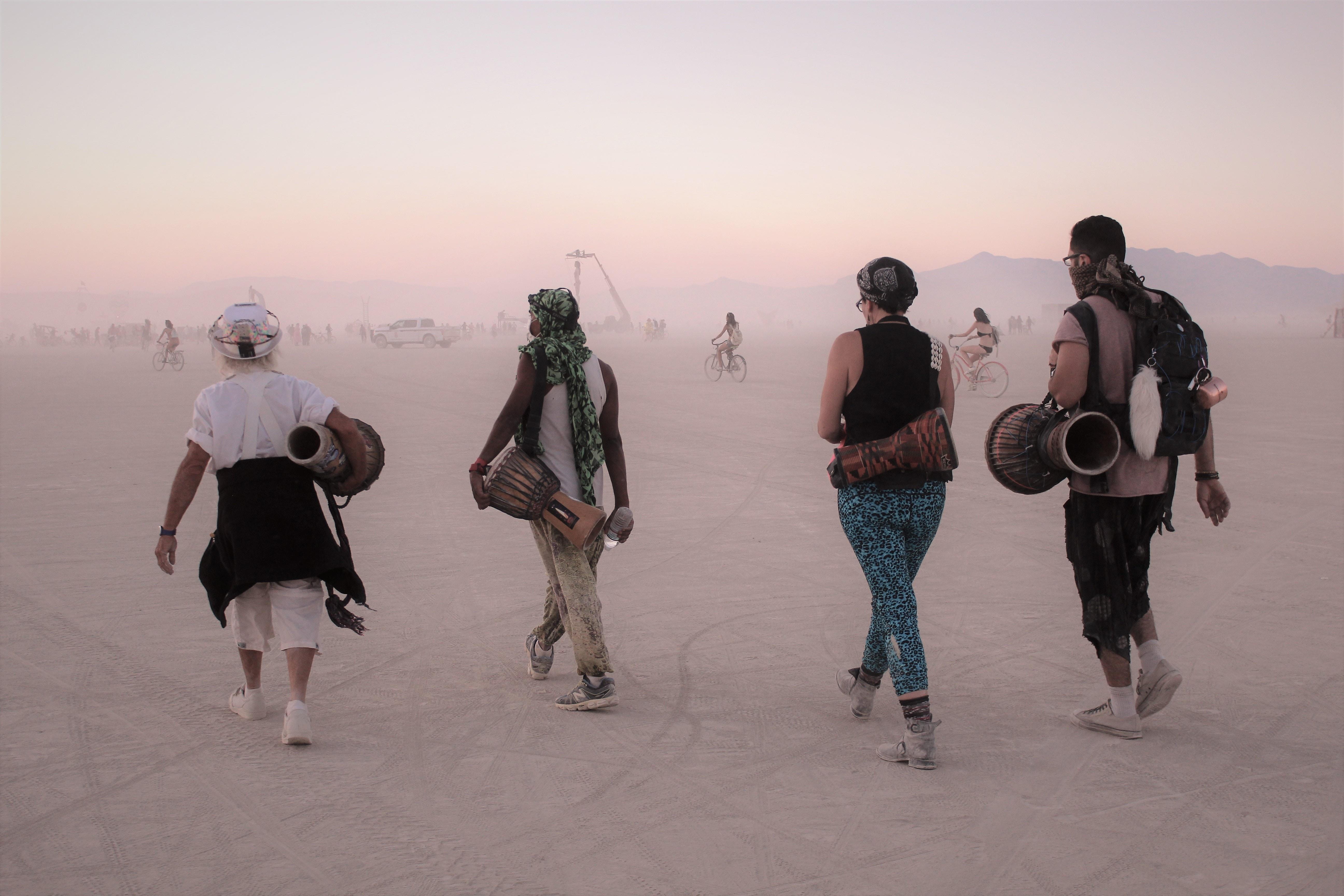 Four drummers on beach