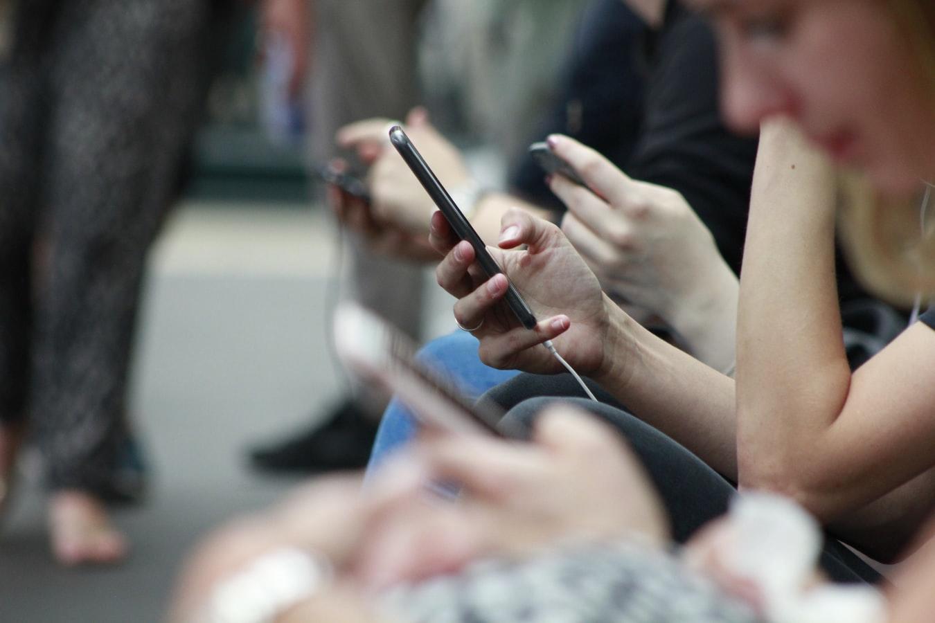 people texting on smartphones