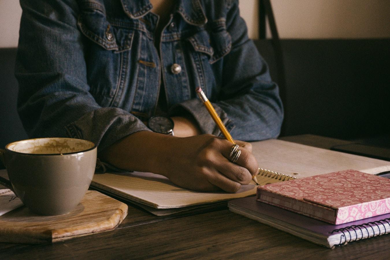 woman writing with pen on paper