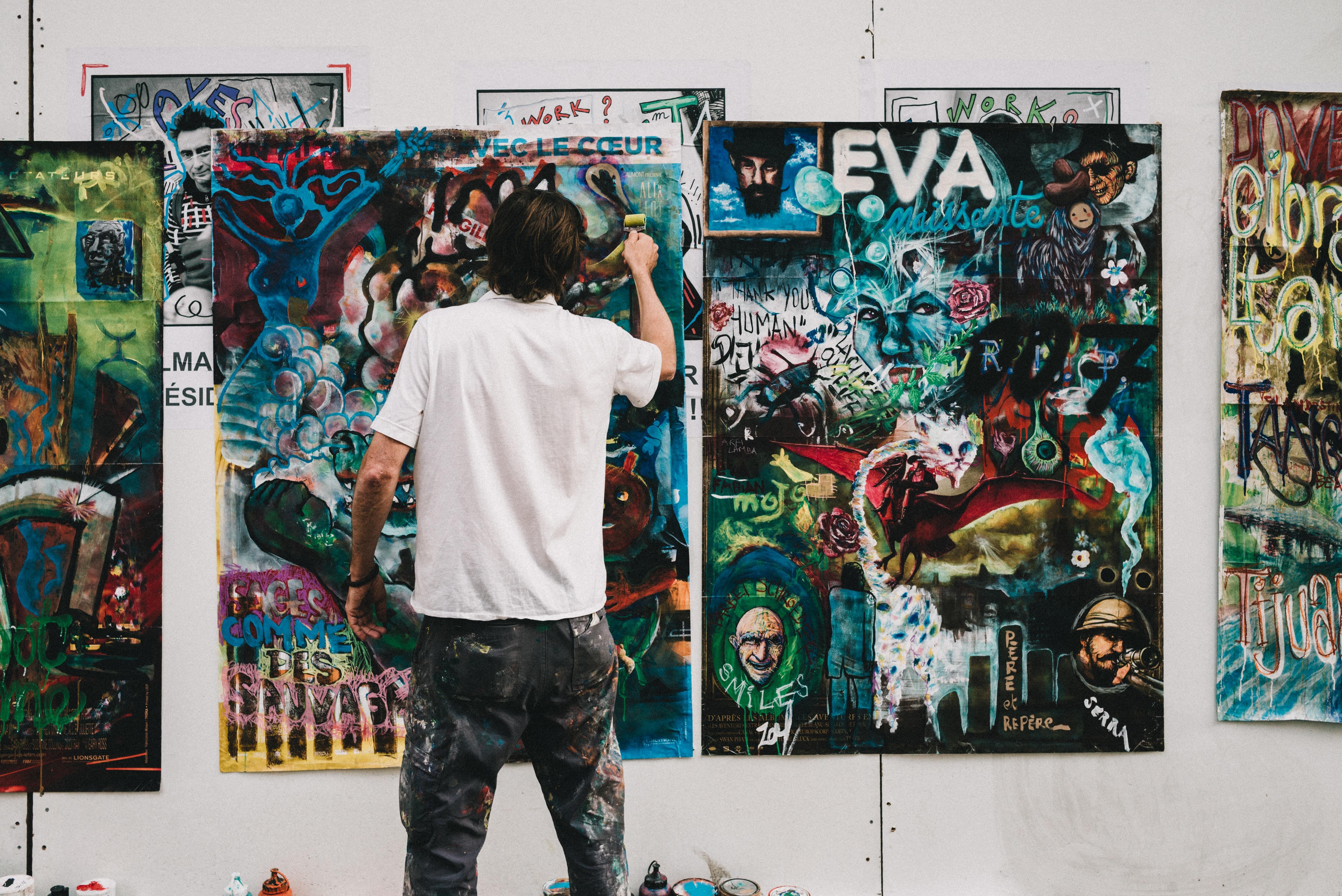 man painting art in studio
