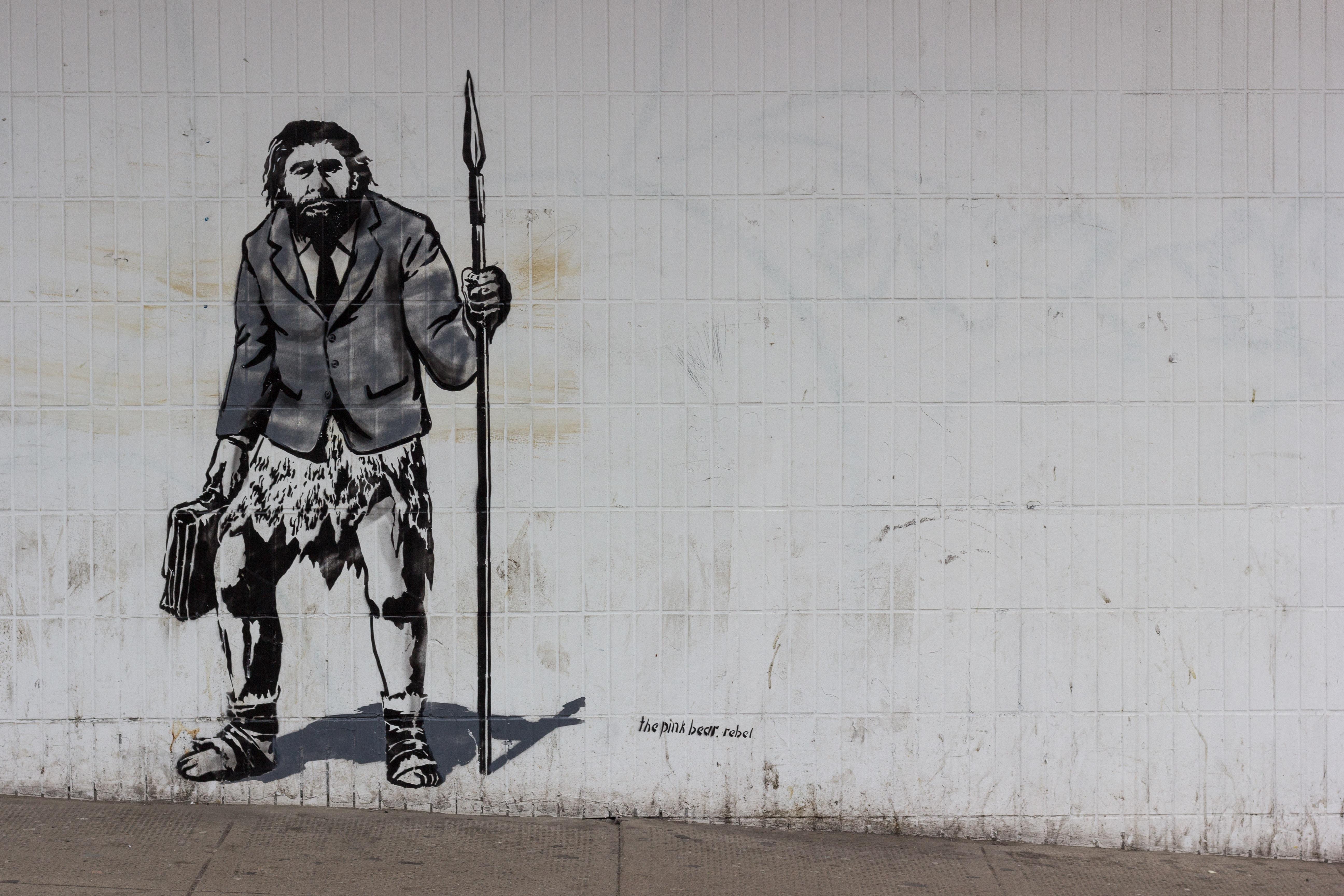 street art depicting Neanderthal in modern clothes