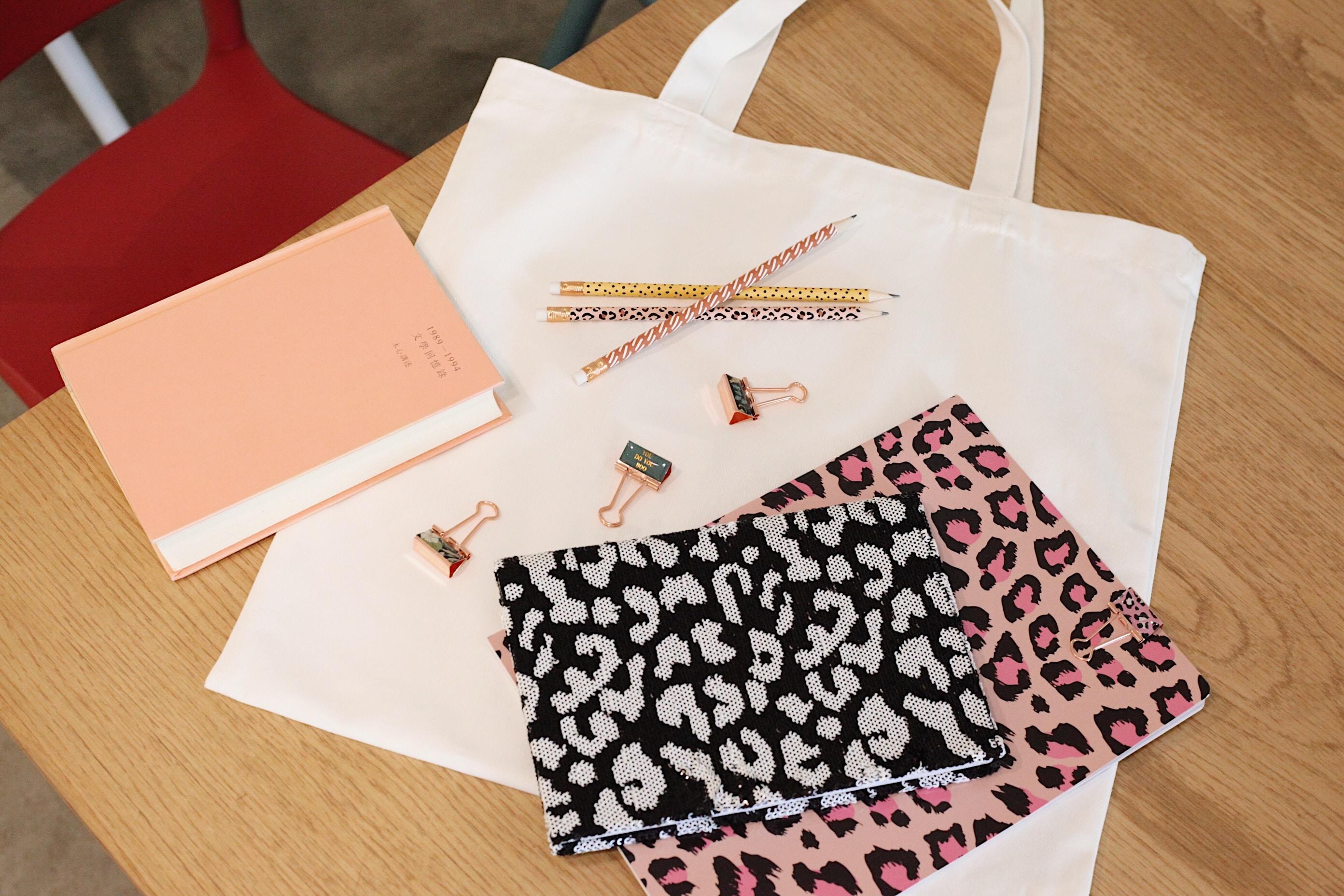 notebooks and stationery plus totebag on desk
