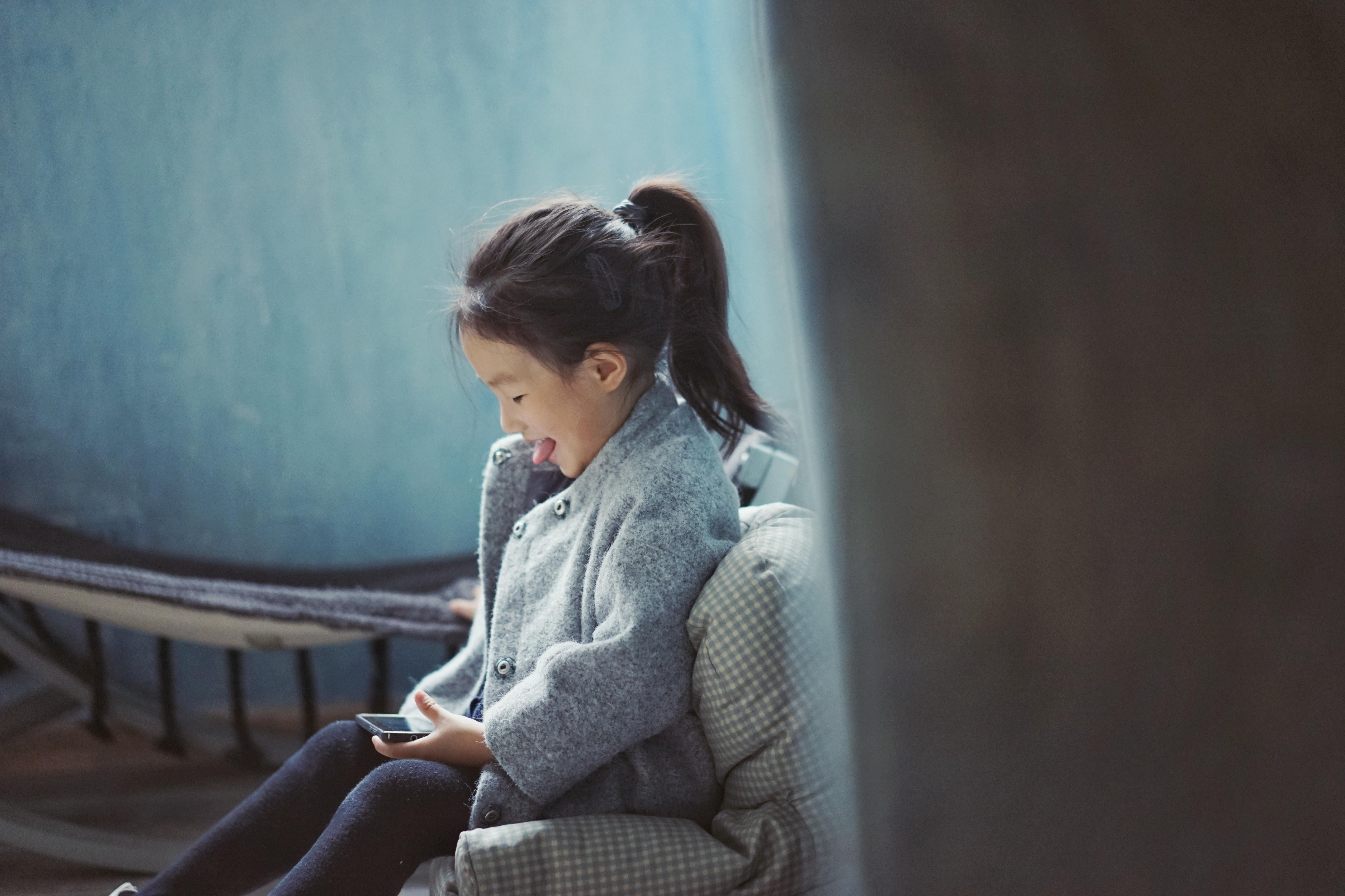 girl playing games on smartphone