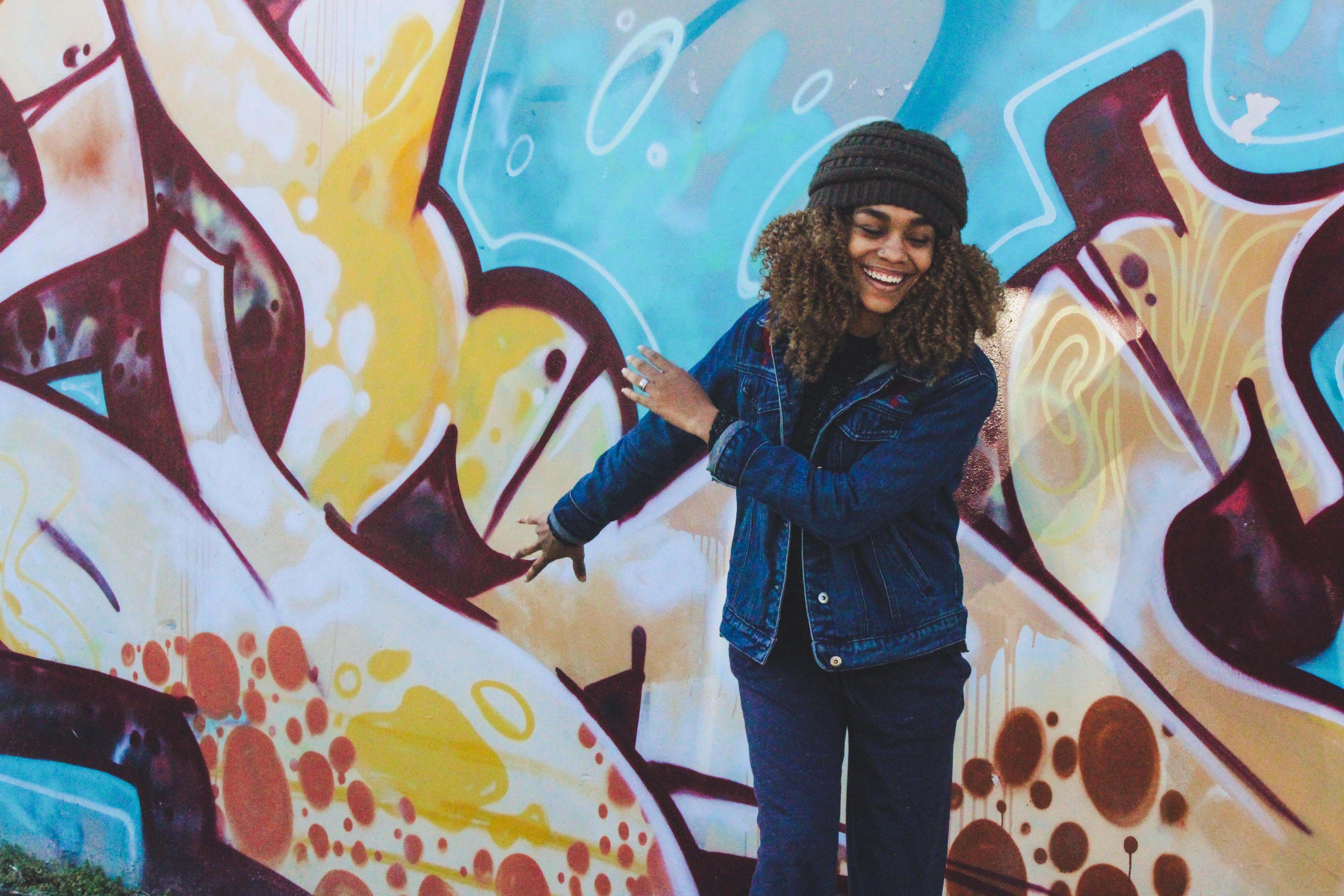 woman in front of street art