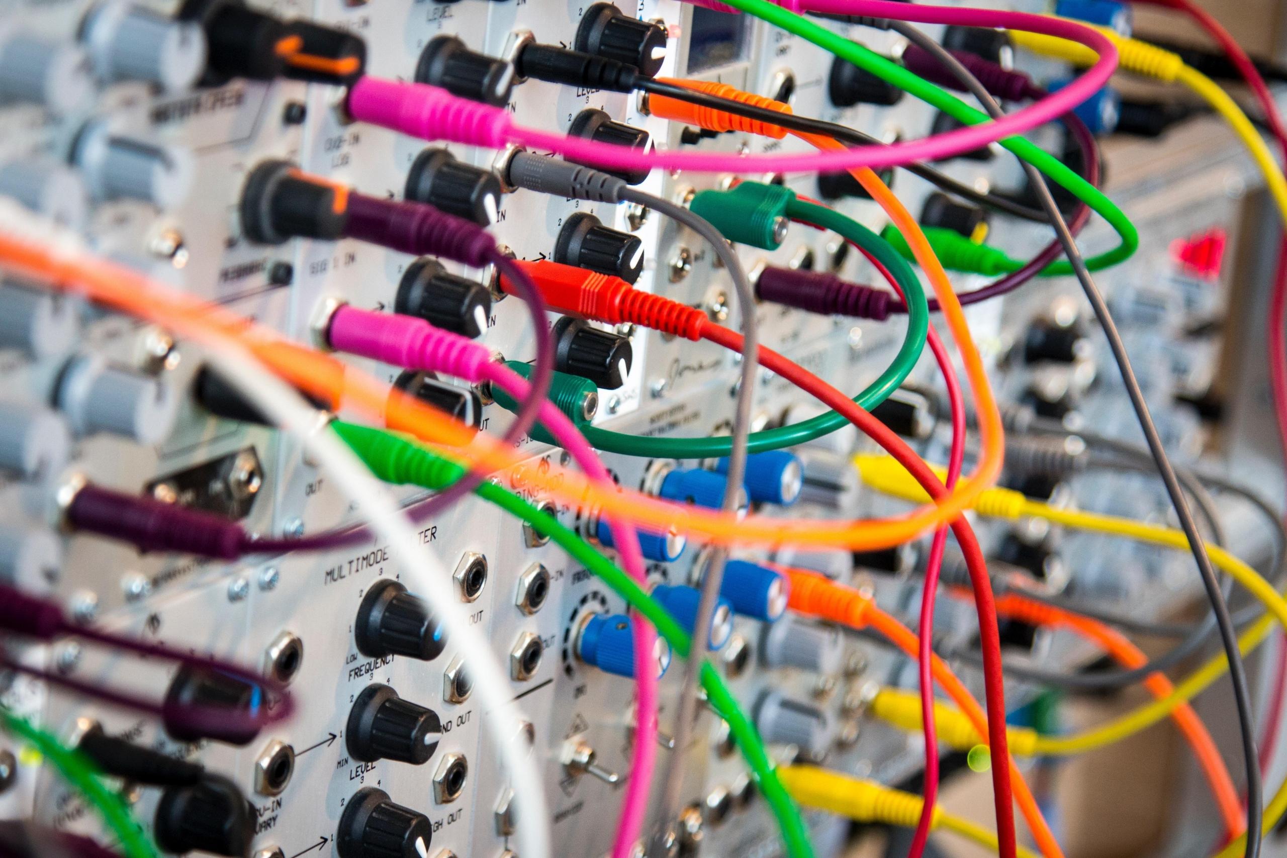 assorted electrical cables plugged into circuit board