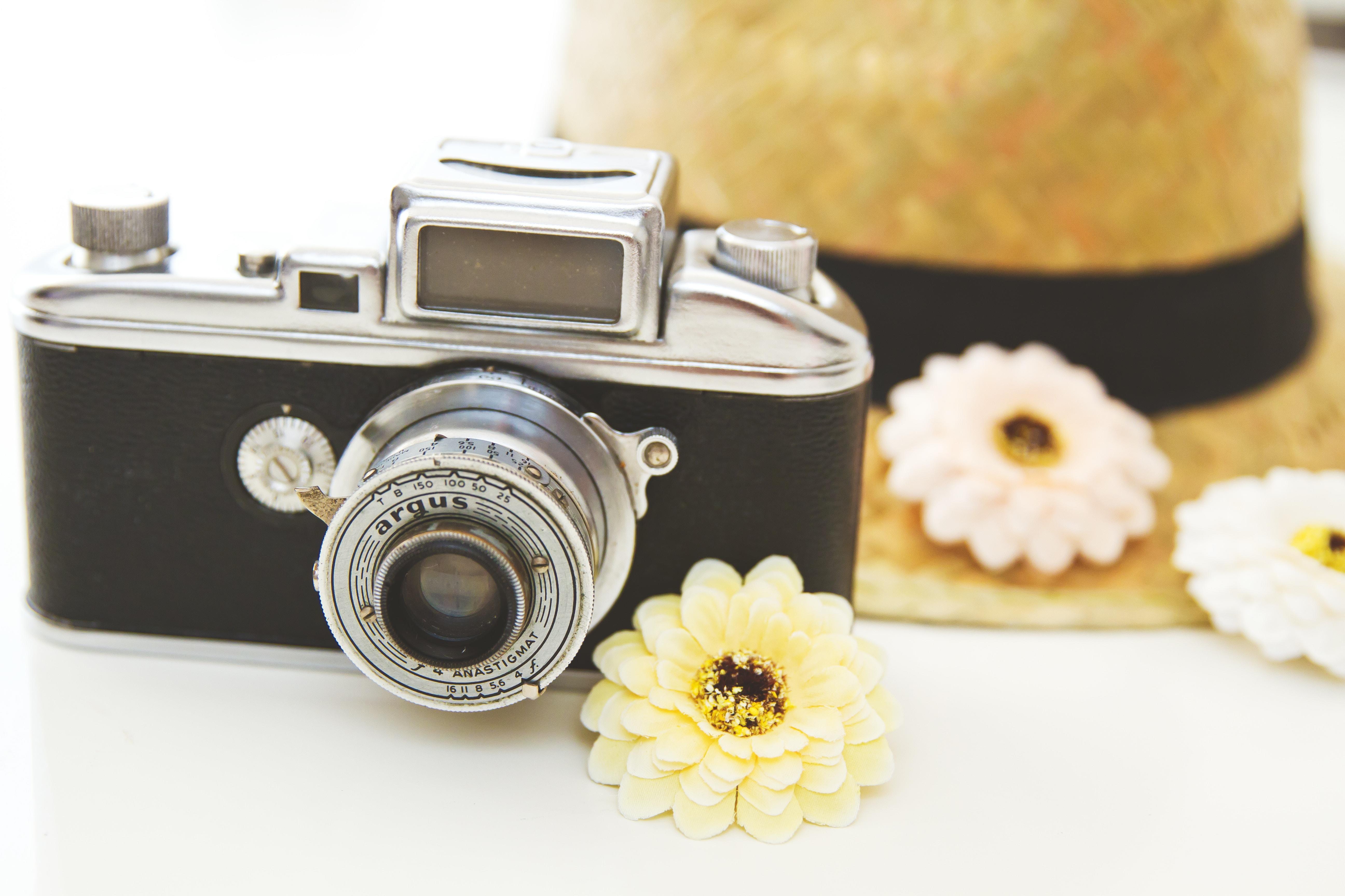 black SLR camera on white surface