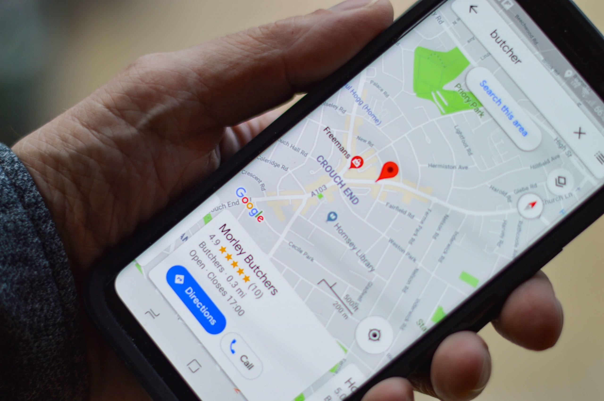 person holding mobile phone and using GPS