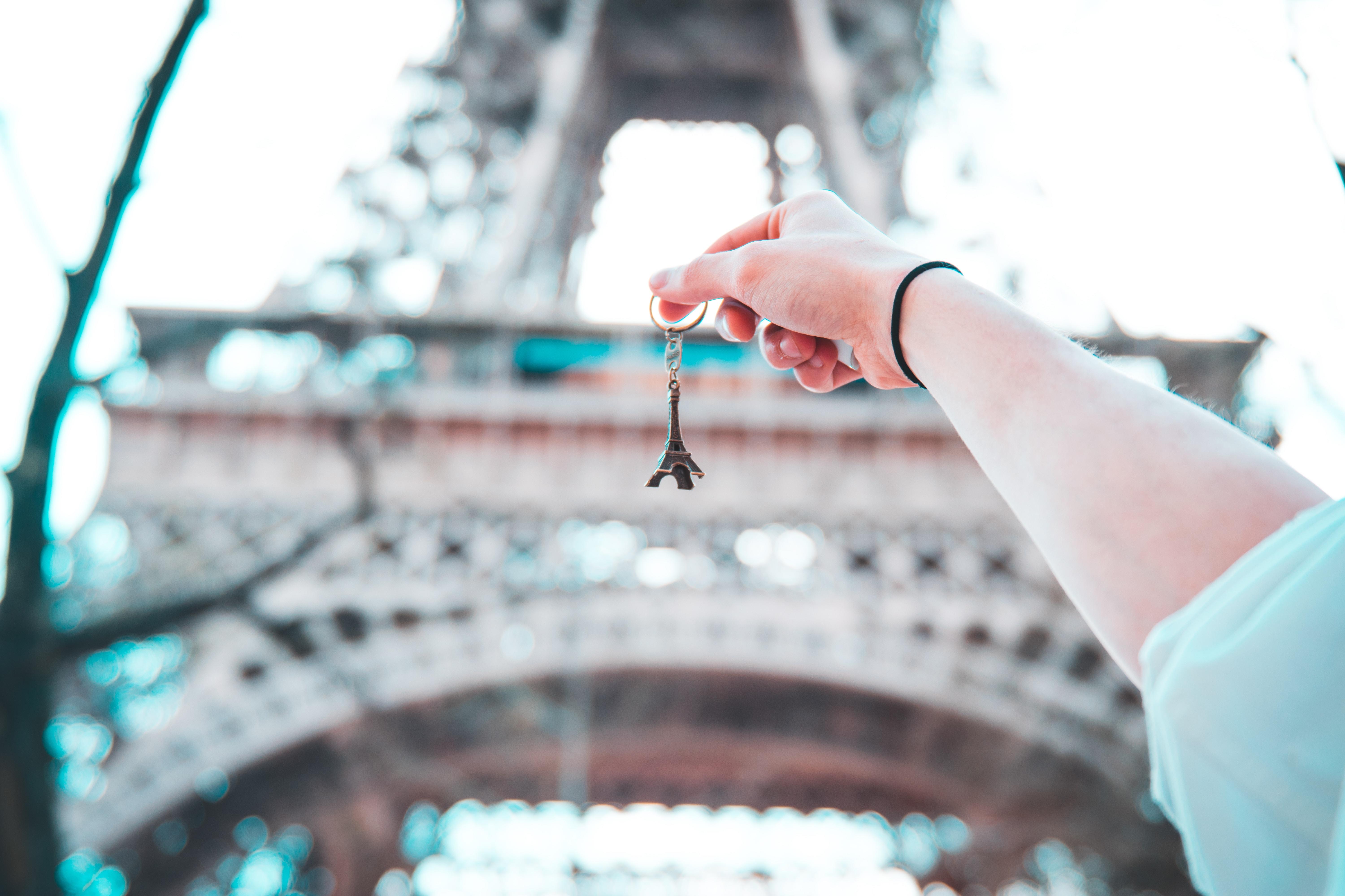 person holding eiffel tower keyring under Eiffel Tower