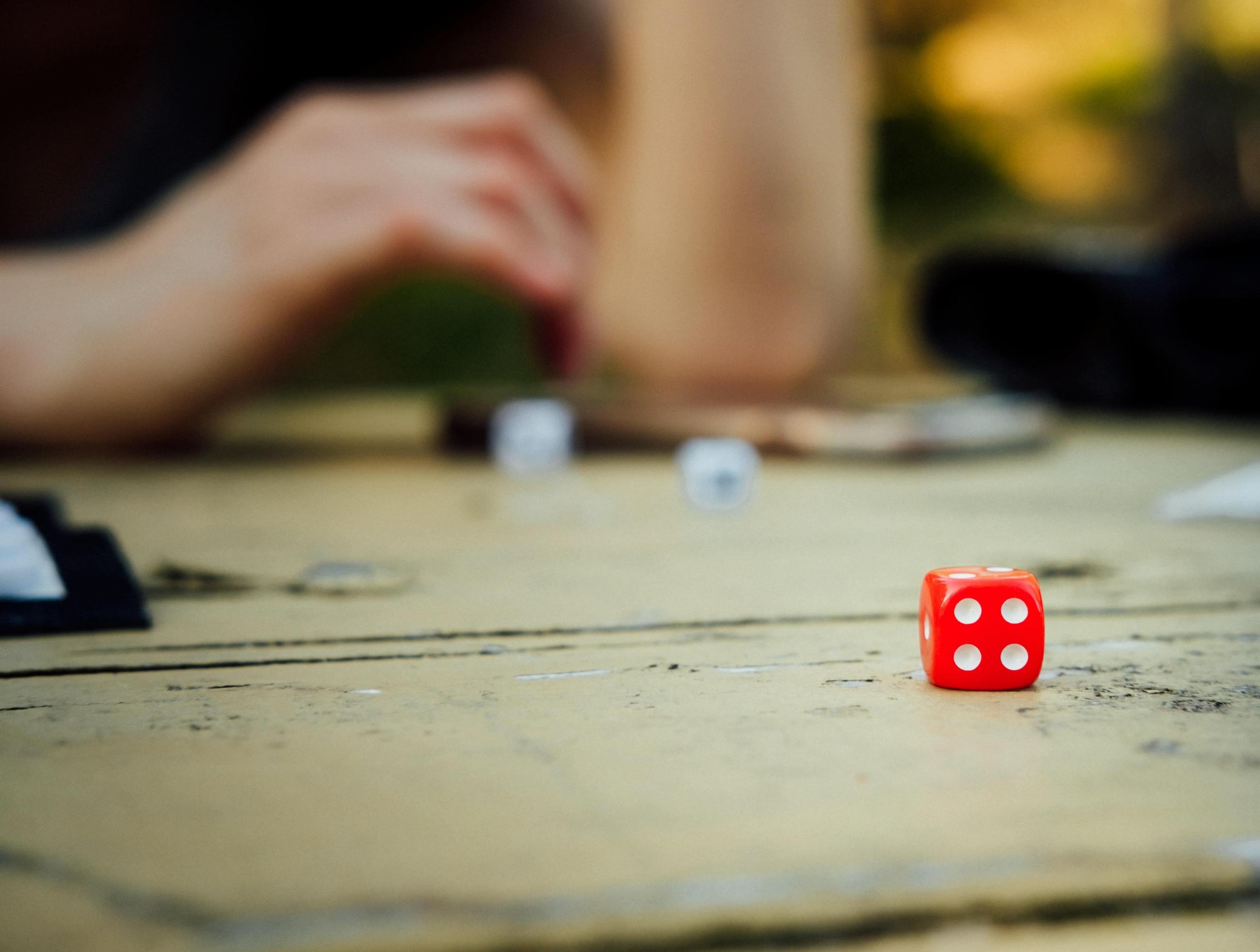 close-up photo of boardgame and red die