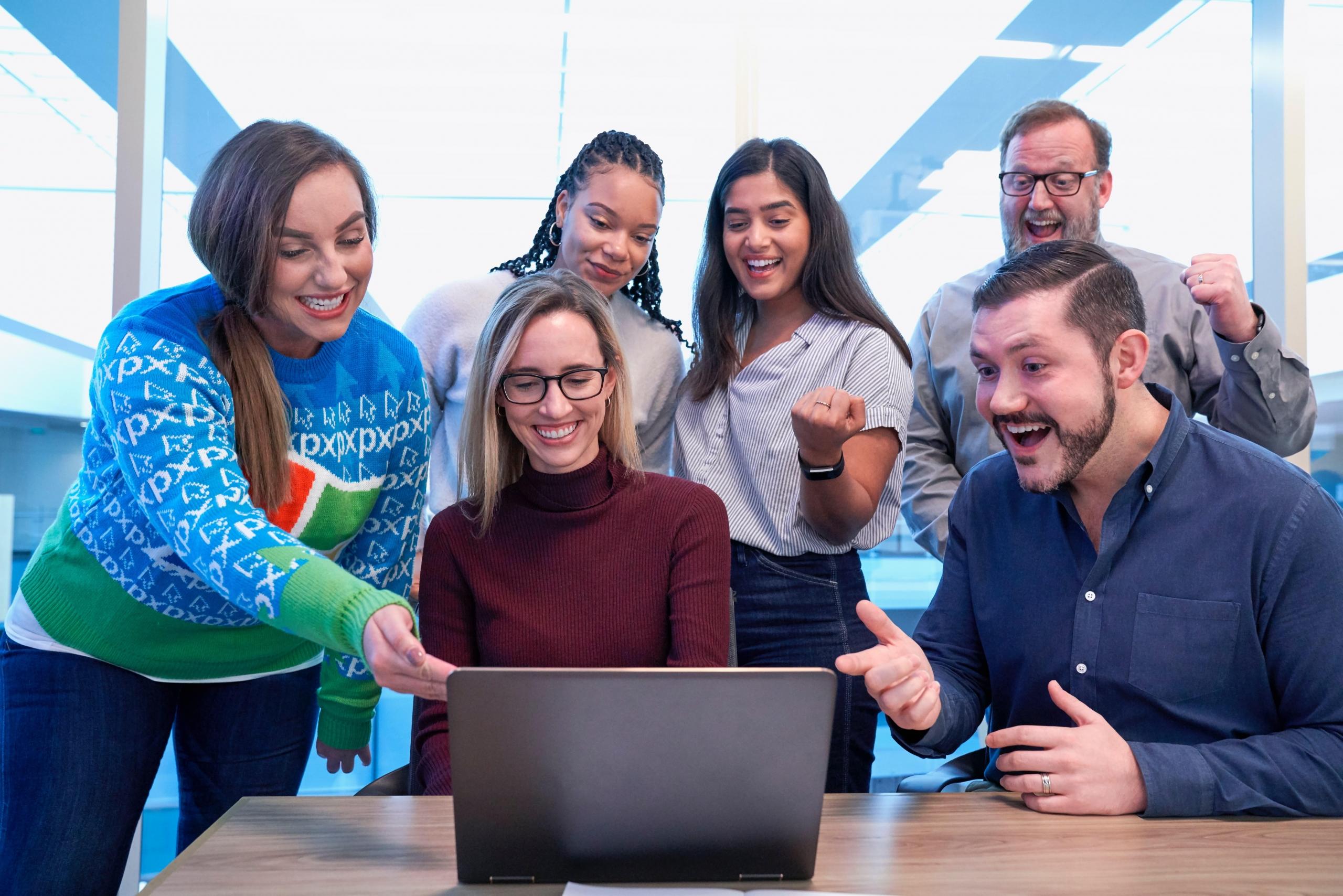 team of people using laptop