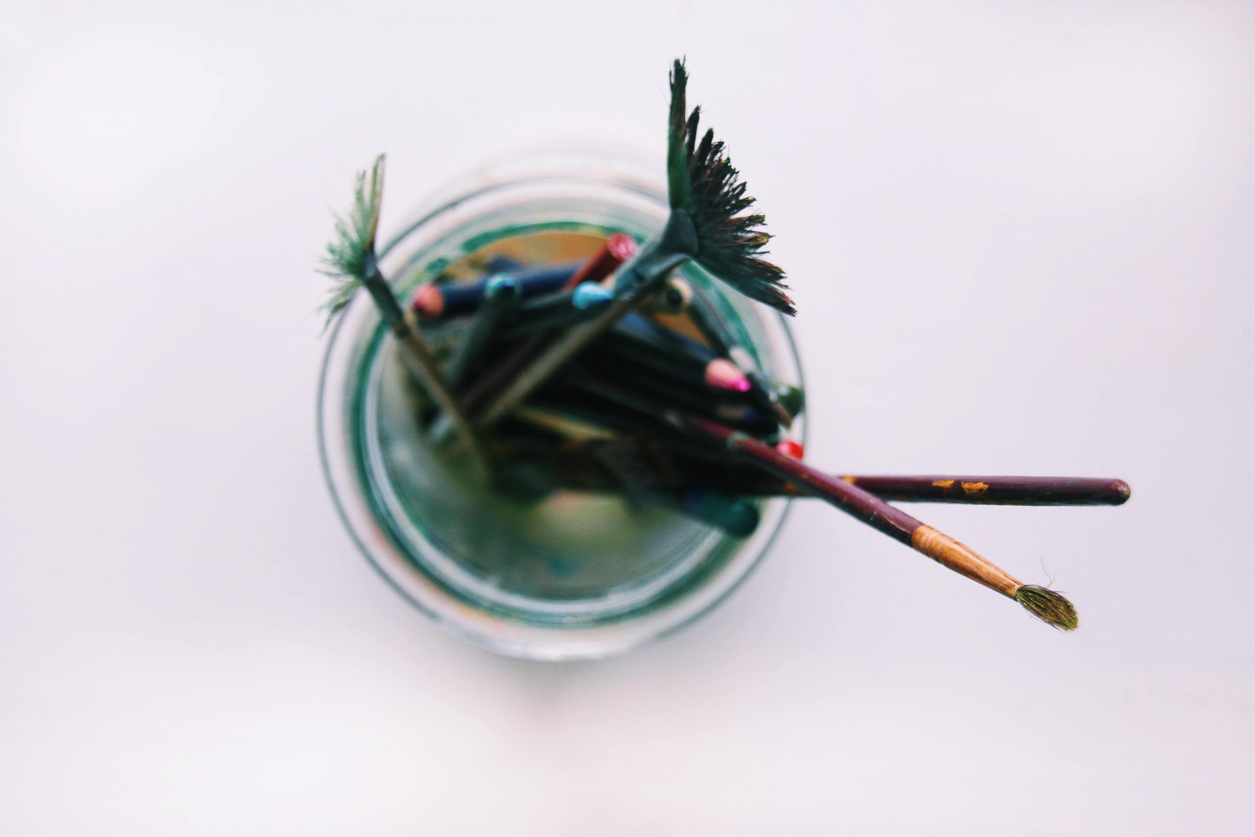 assorted paint brushes in jar
