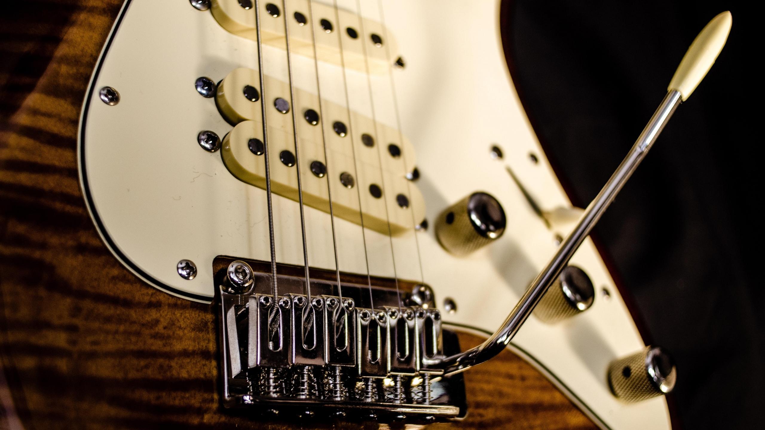 selective focus photography of white and brown electric guitar