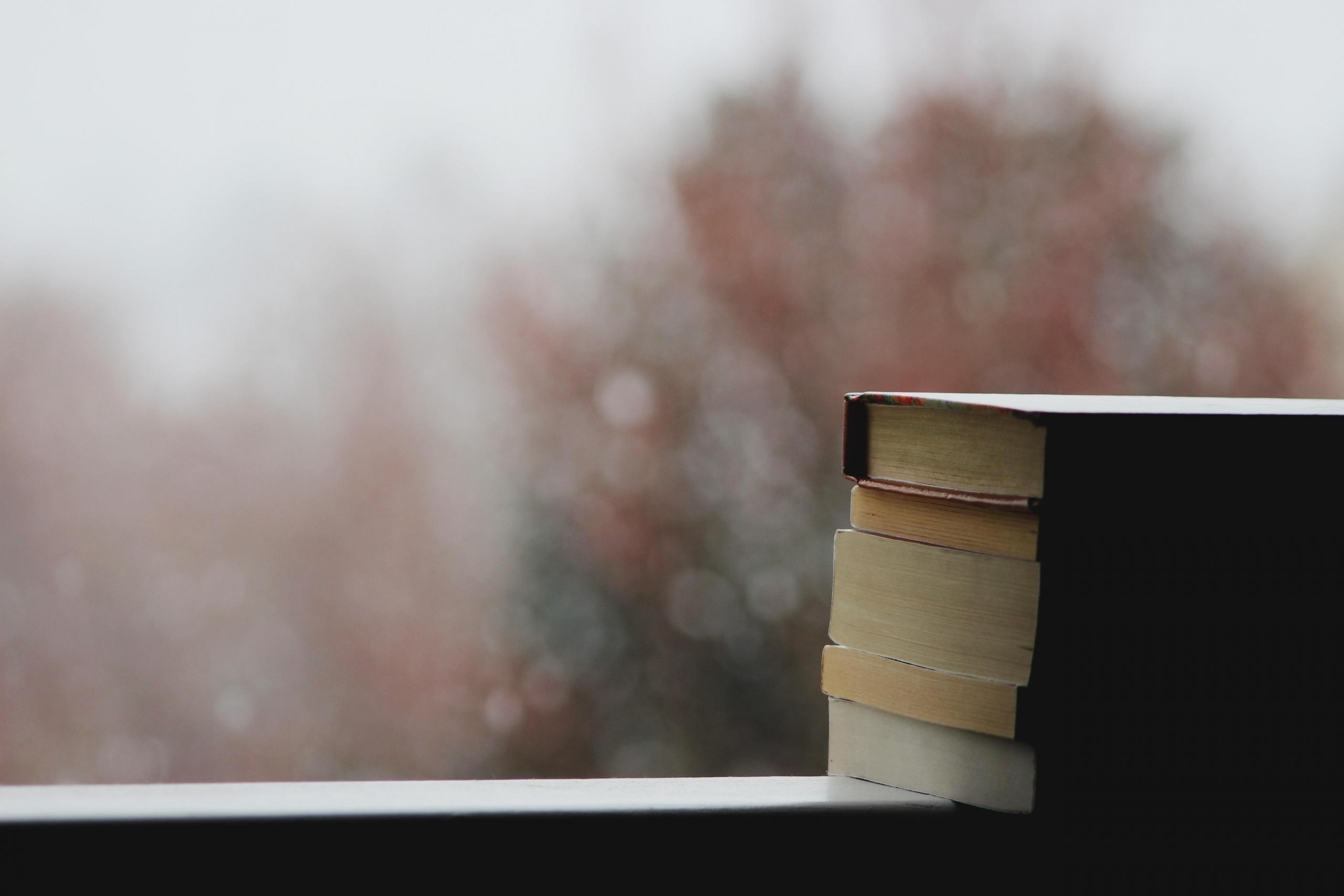 books stacked on windowsill