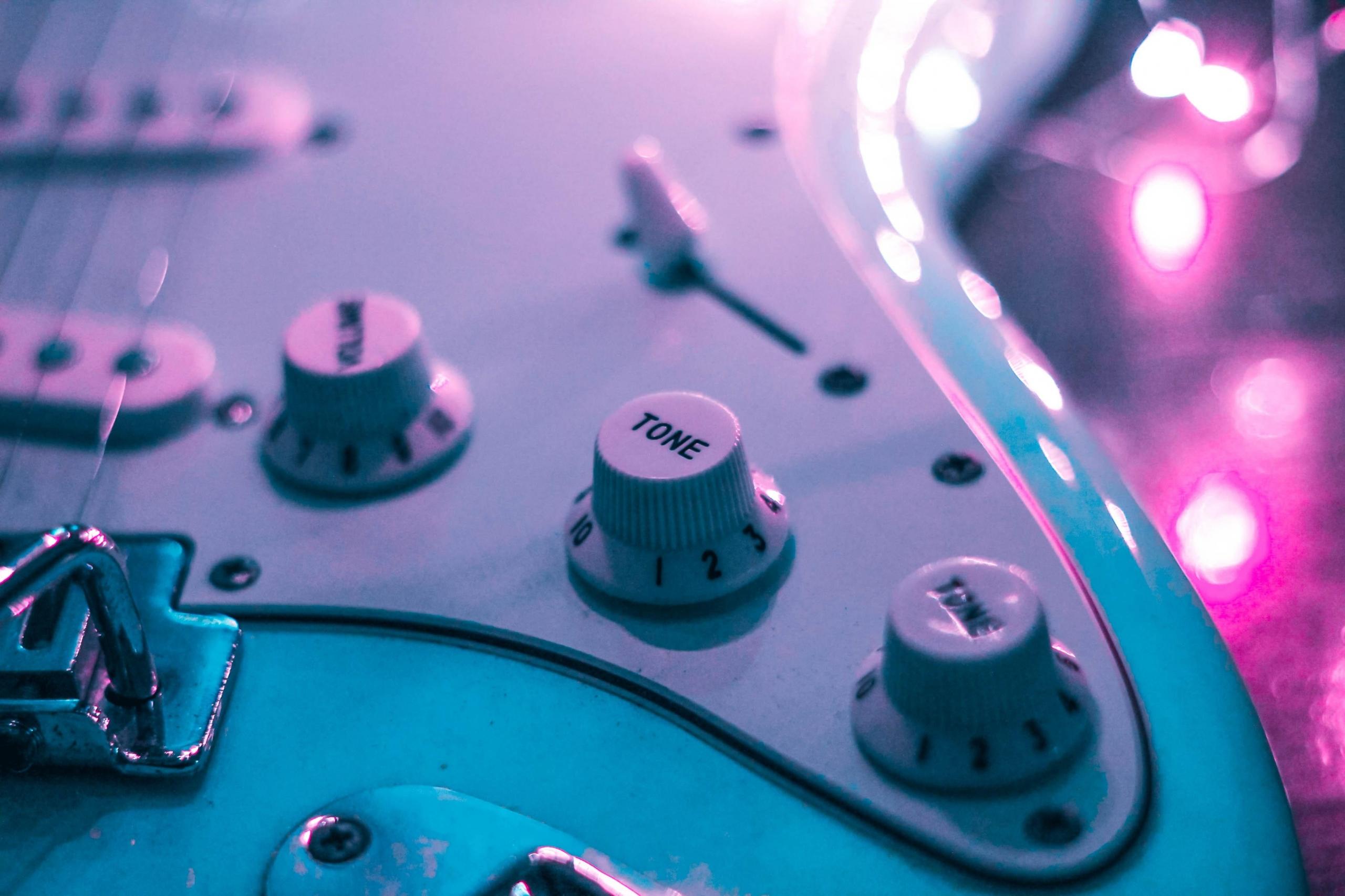 electric guitar under pink lights