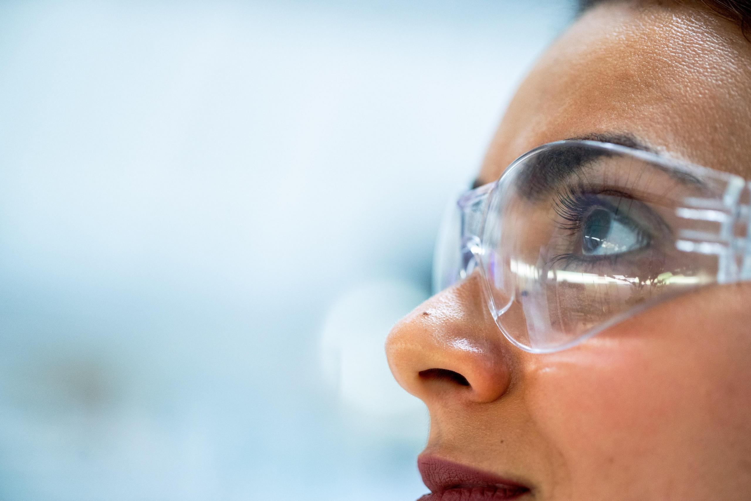female scientist wearing protective glasses