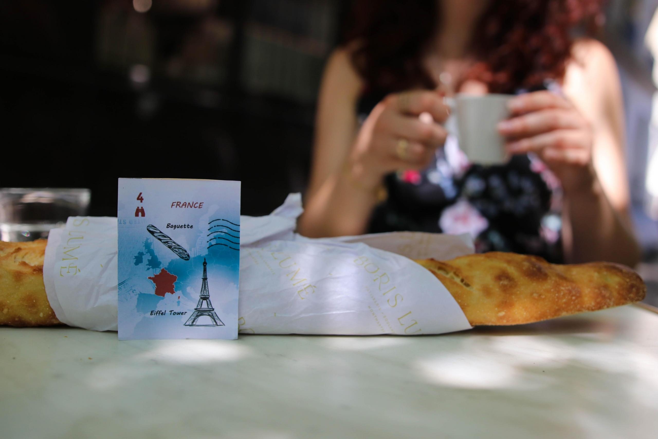 baguette and coffee on table at cafe in Paris