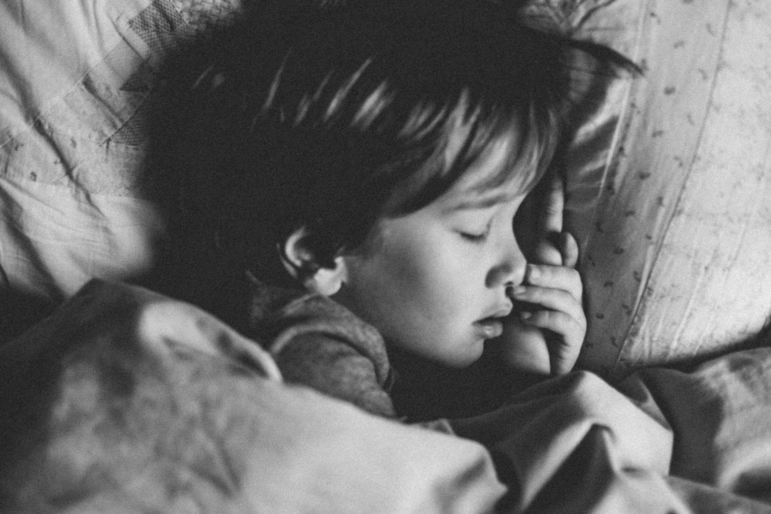 little boy asleep in bed