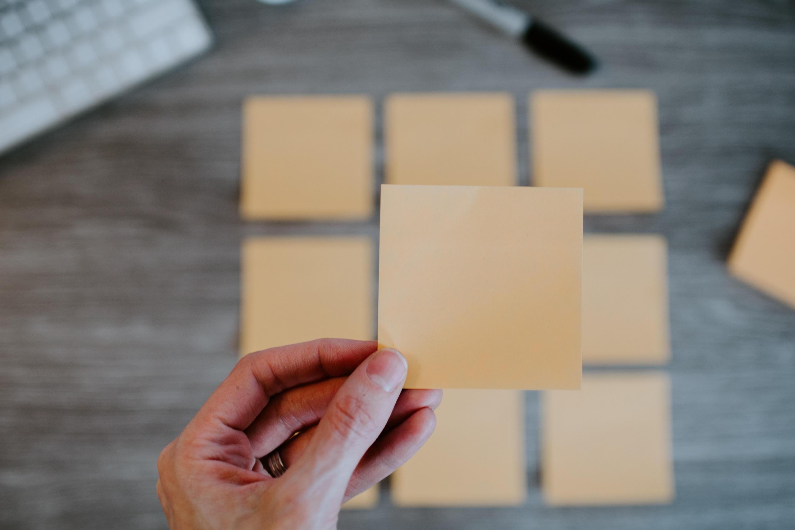 woman holding blank sticky note