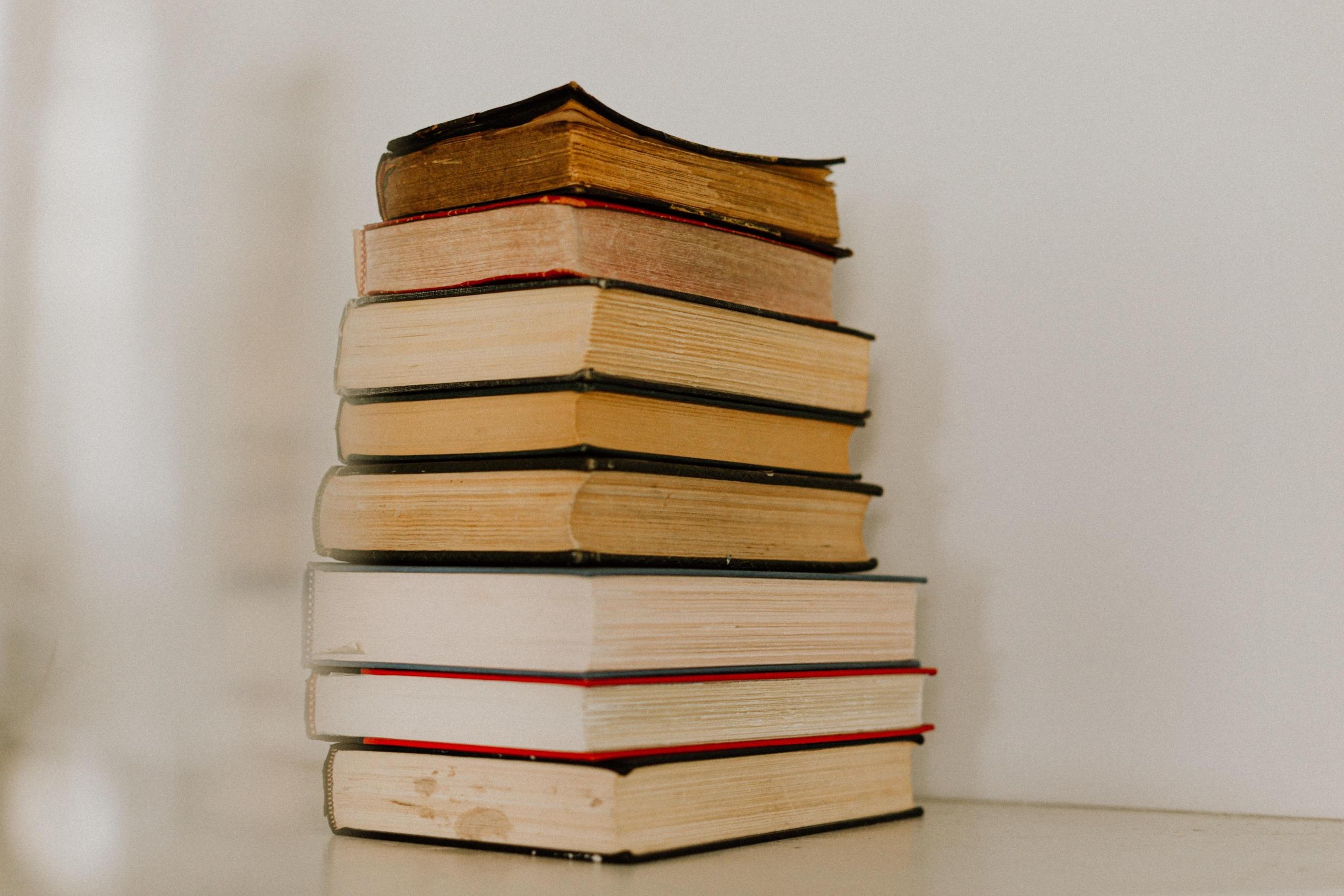 books stacked neatly against wall