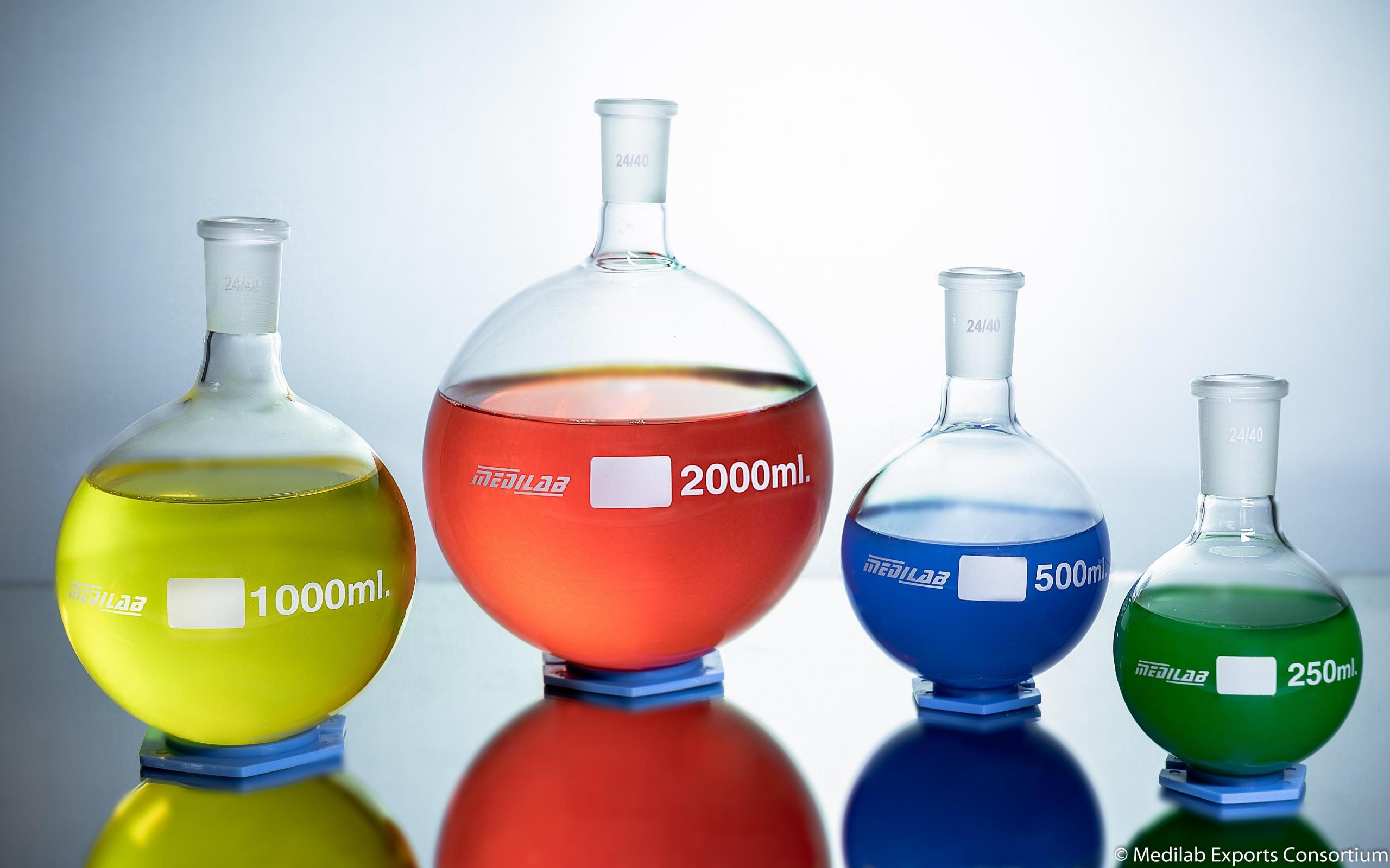 colourful liquids in beakers on table