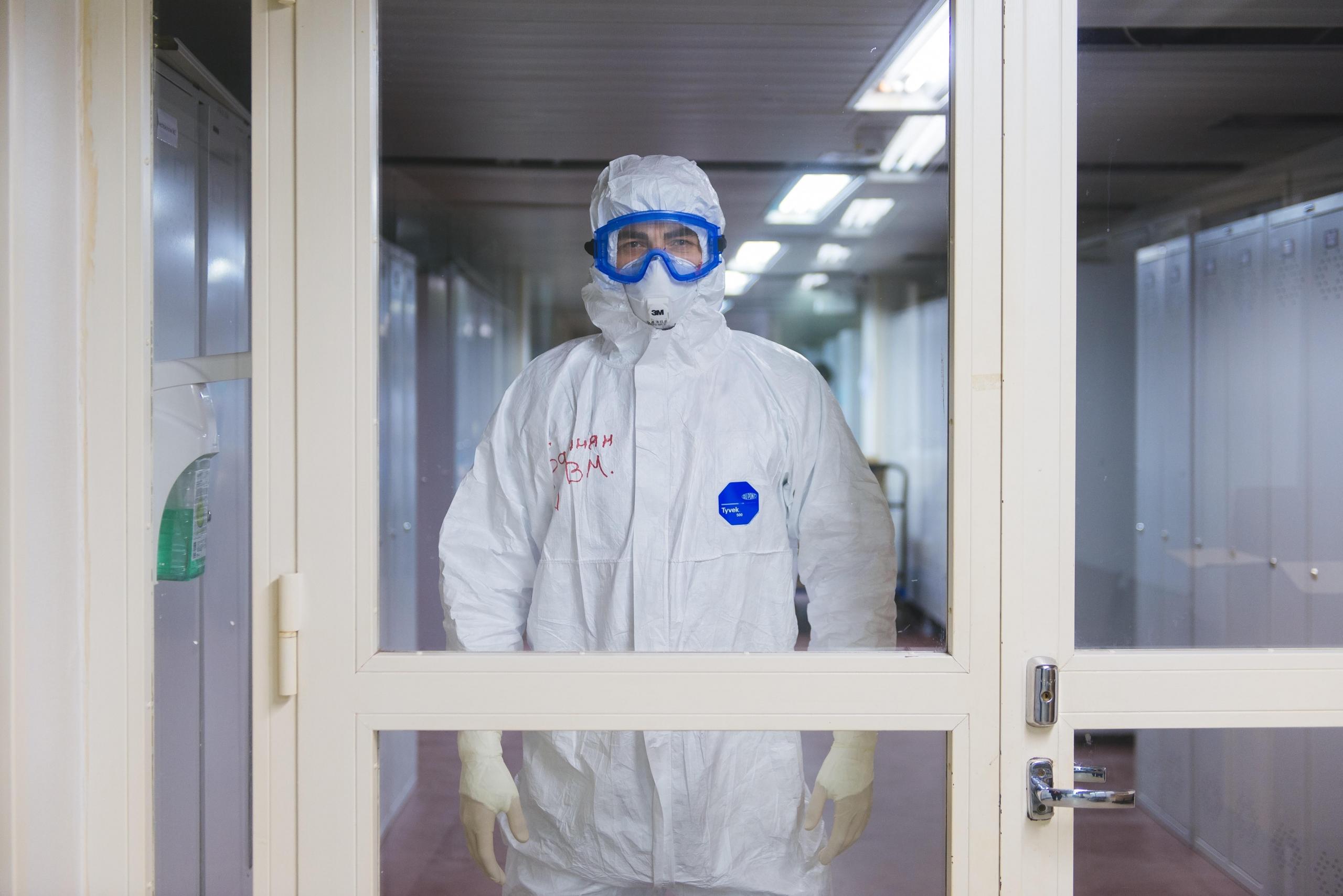 scientist wearing protective suit, goggles and gloves