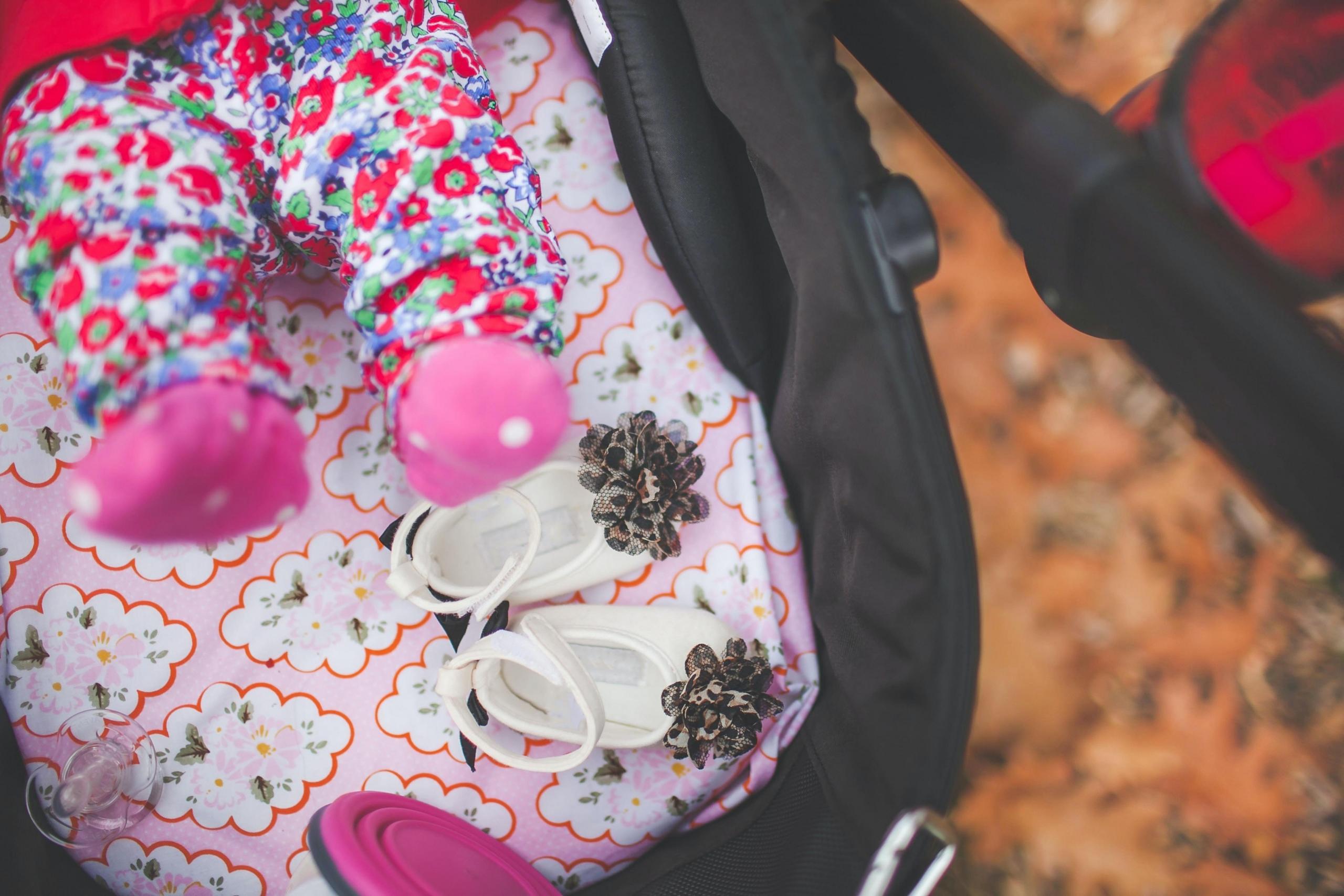 baby girl lying in stroller