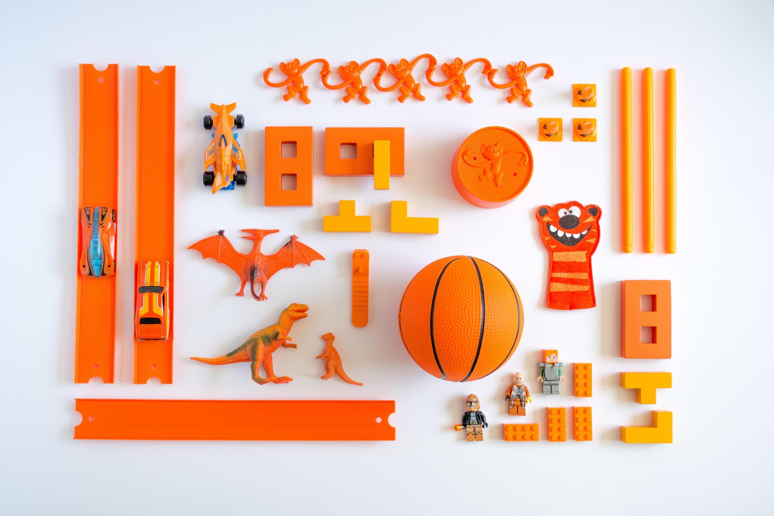 selection of orange toys arranged in pattern