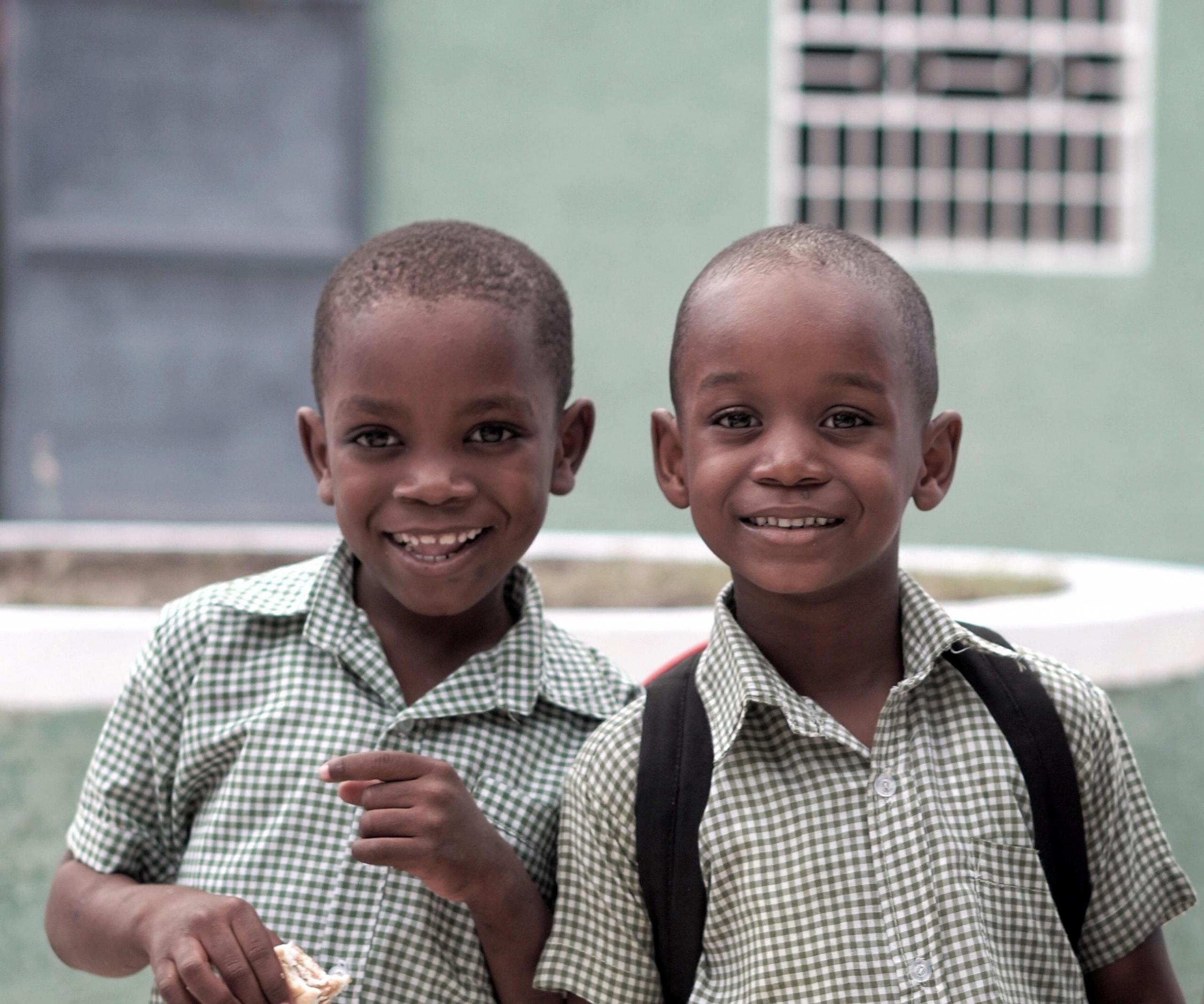 two young schoolboys laughing together