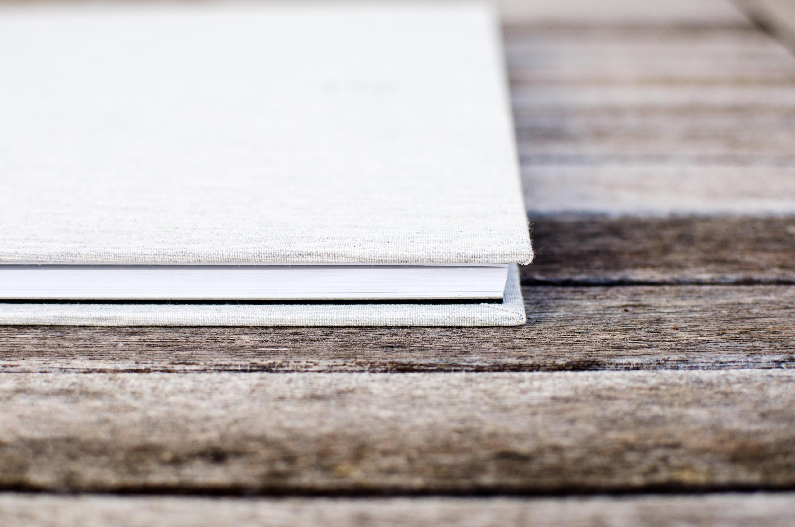 white book on wooden table