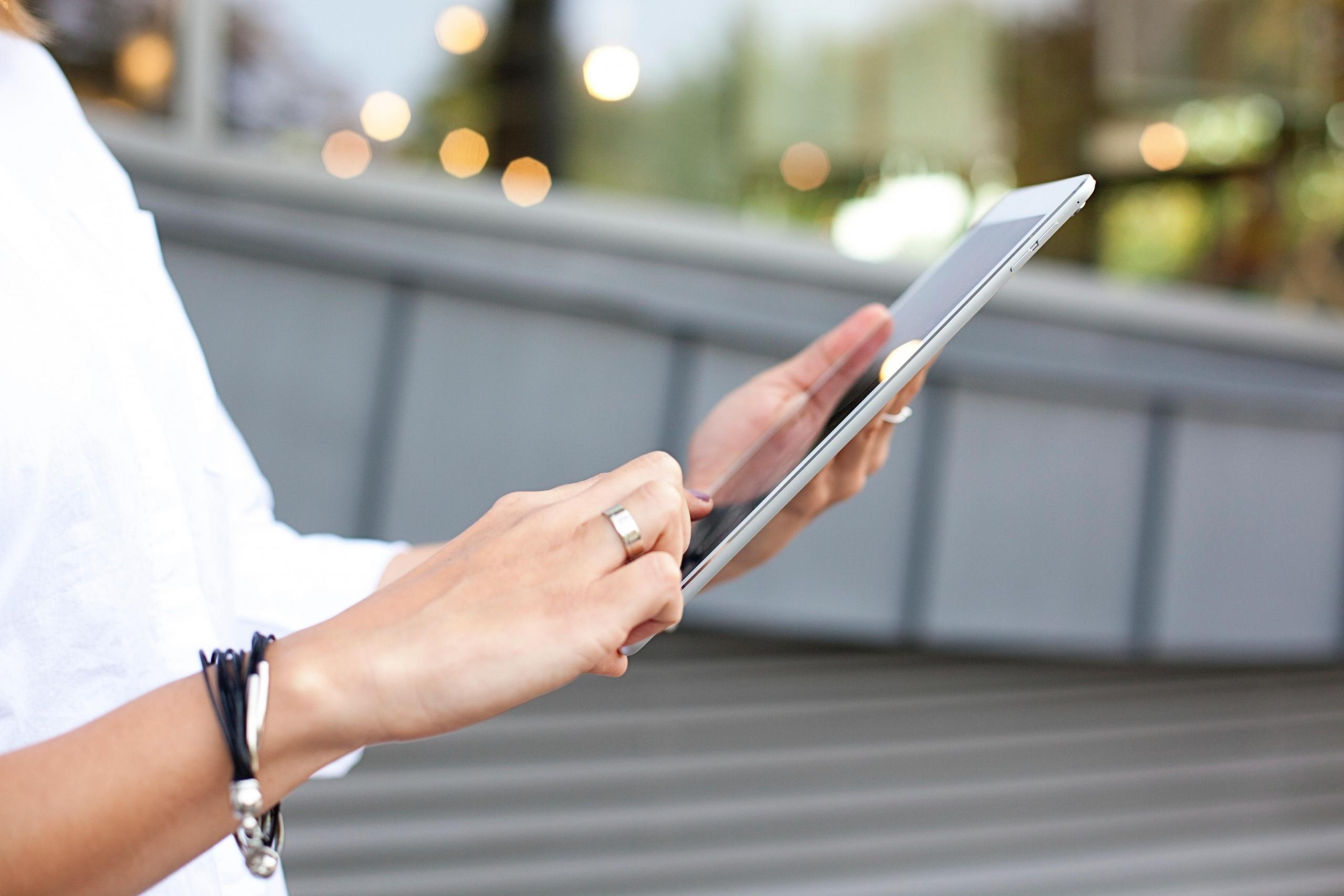 woman using tablet outdoors