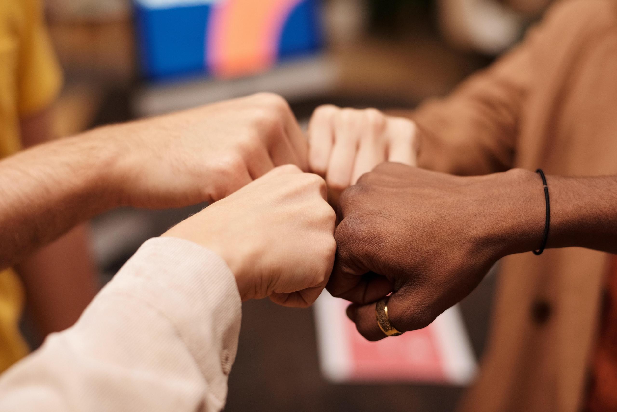 people fist bumping each other