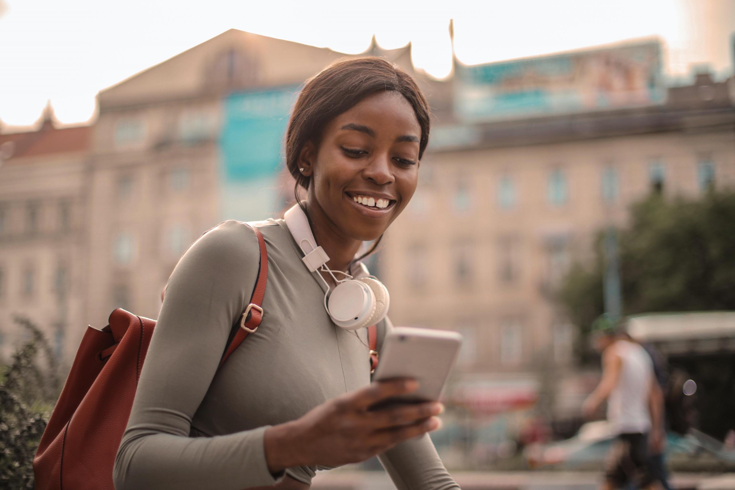 girl using phone and headphones